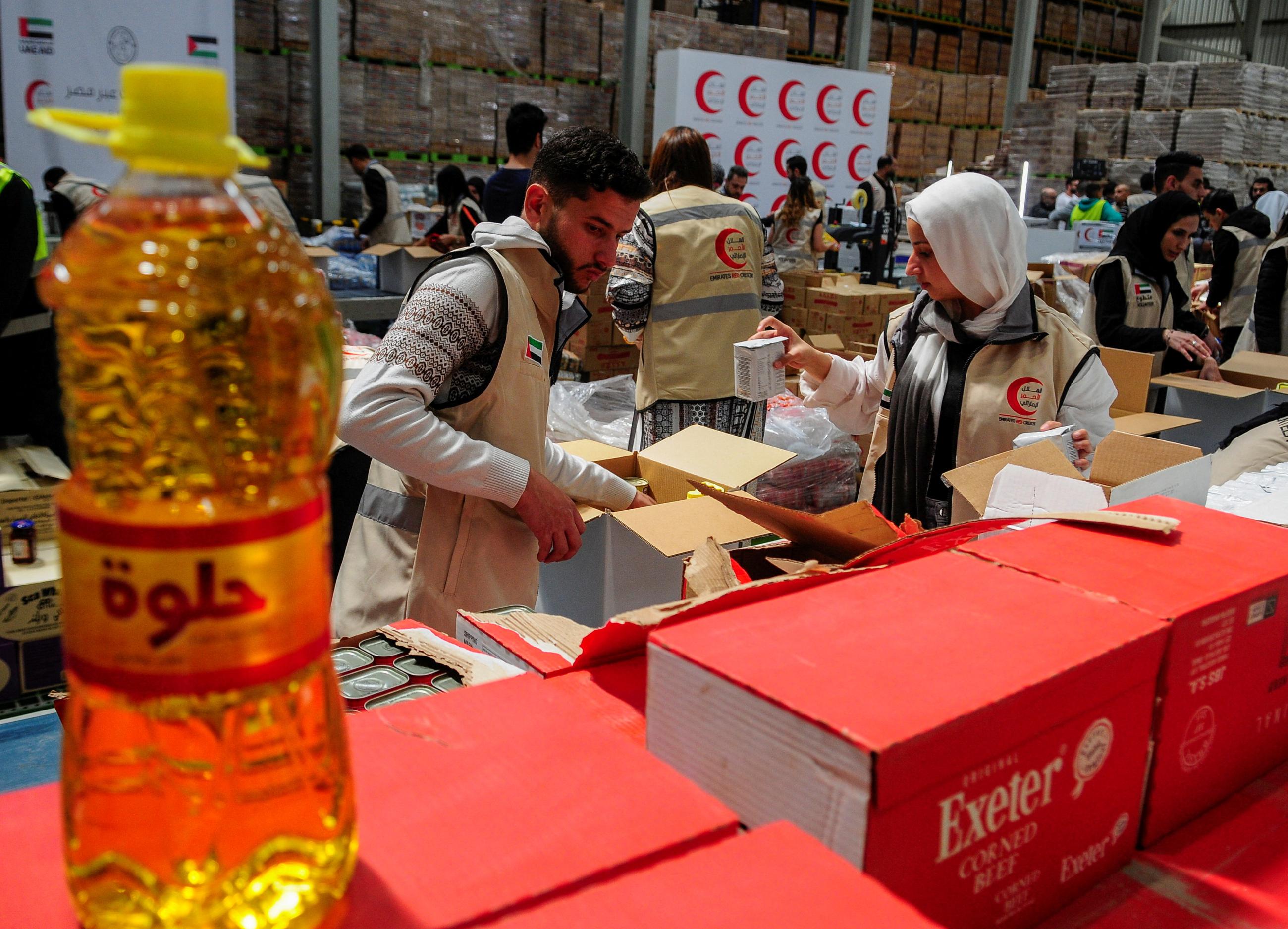 Volunteers from Emirates Red Crescent prepare parcels with humanitarian aid for Gaza to be transferred through the Rafah border crossing.