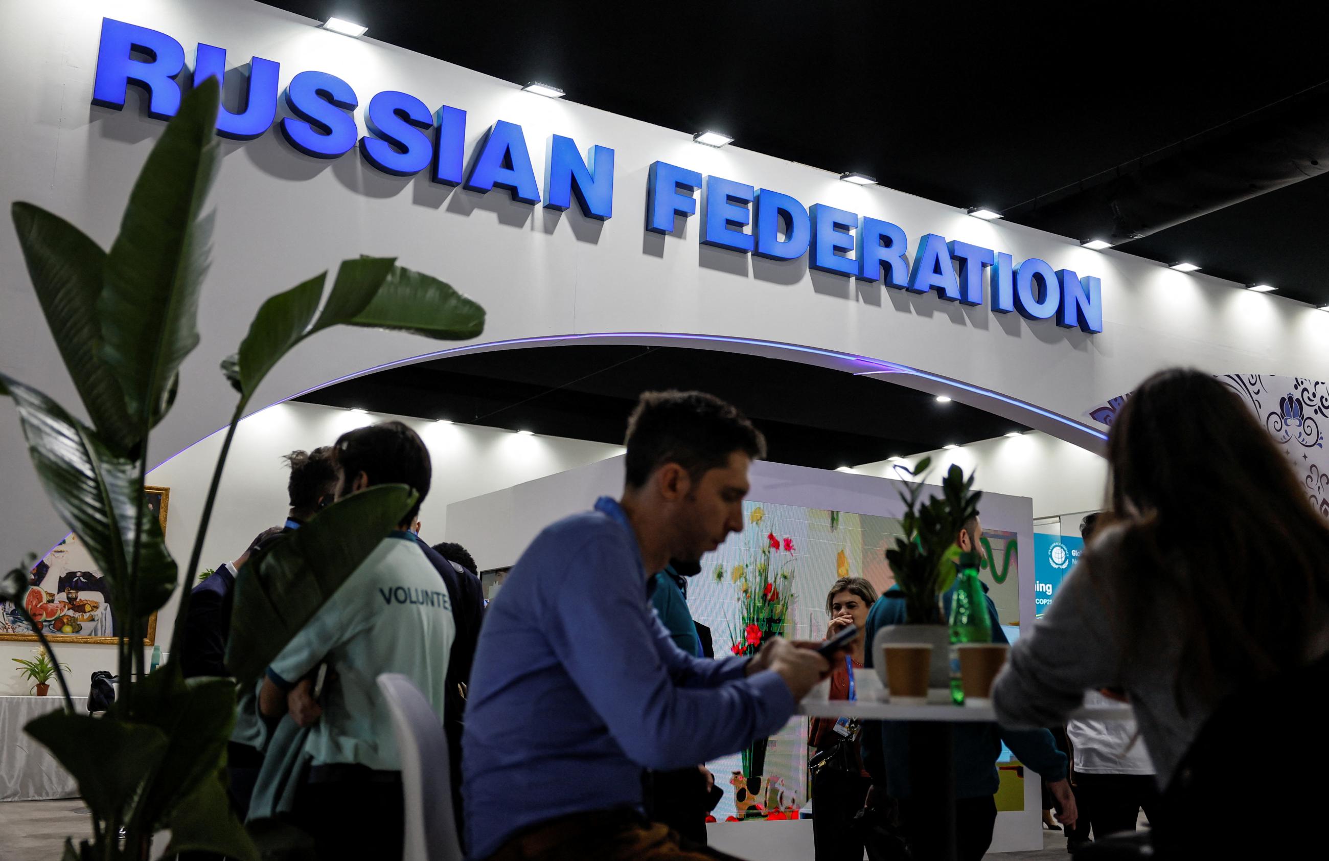 People rest next to the Russia’s stand during the United Nations climate change conference COP29 venue.