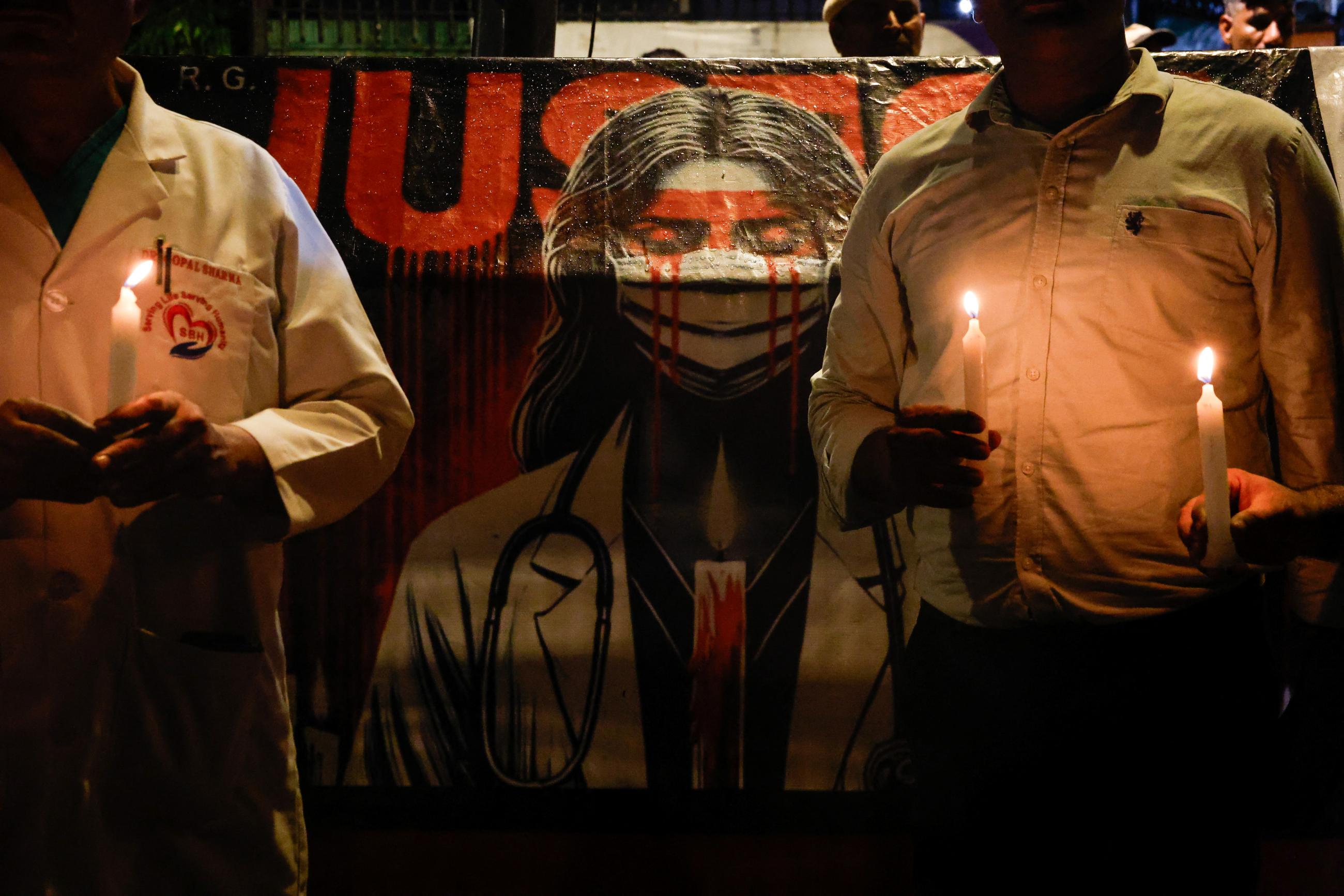 Doctors hold candles during a protest rally demanding justice, following the rape and murder of a trainee medic at a hospital in Kolkata, in New Delhi, India, August 16, 2024.
