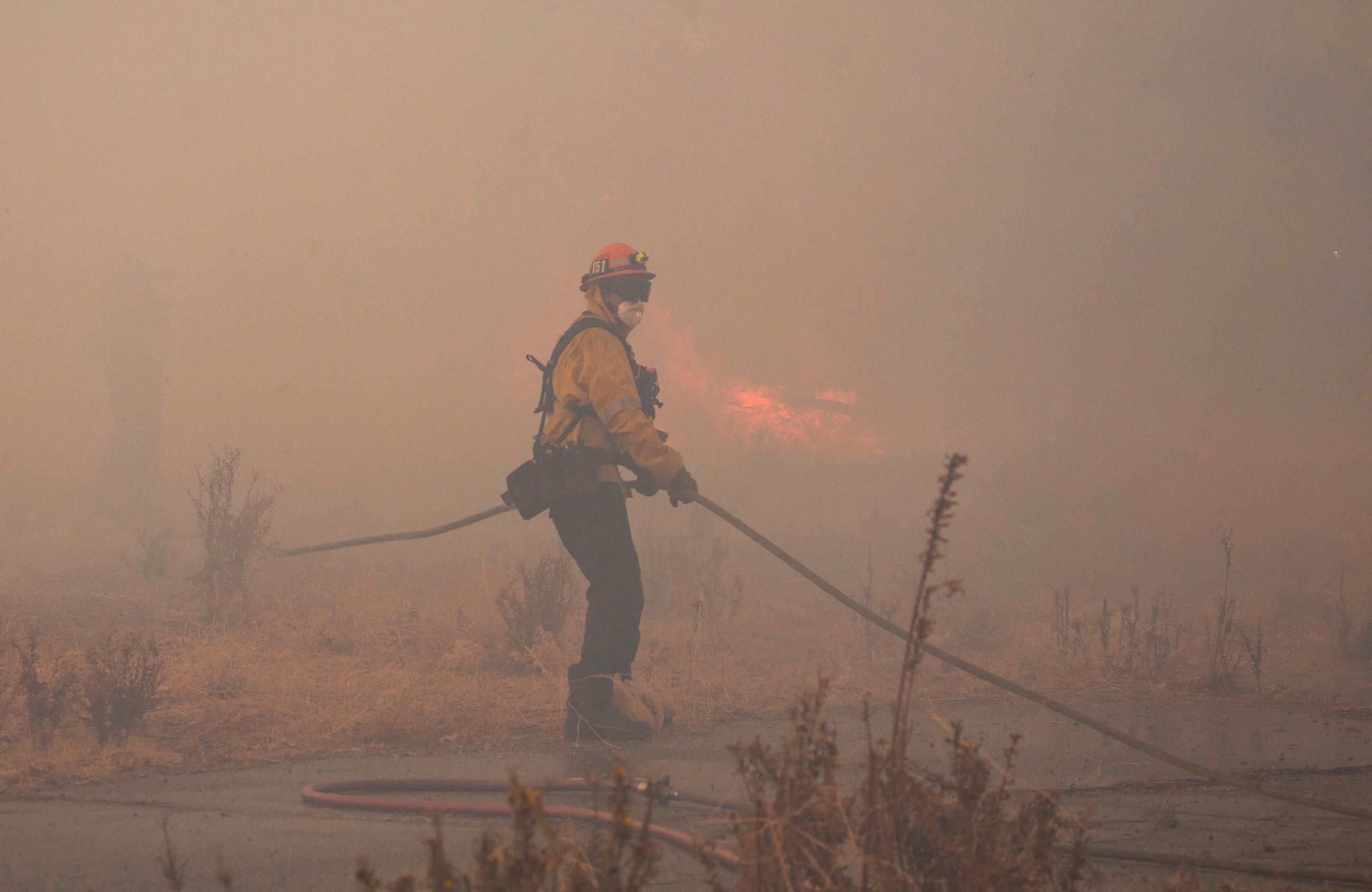 A member of a firefighting crew works to battle the Hughes Fire near Castaic Lake, California, on January 22, 2025. 