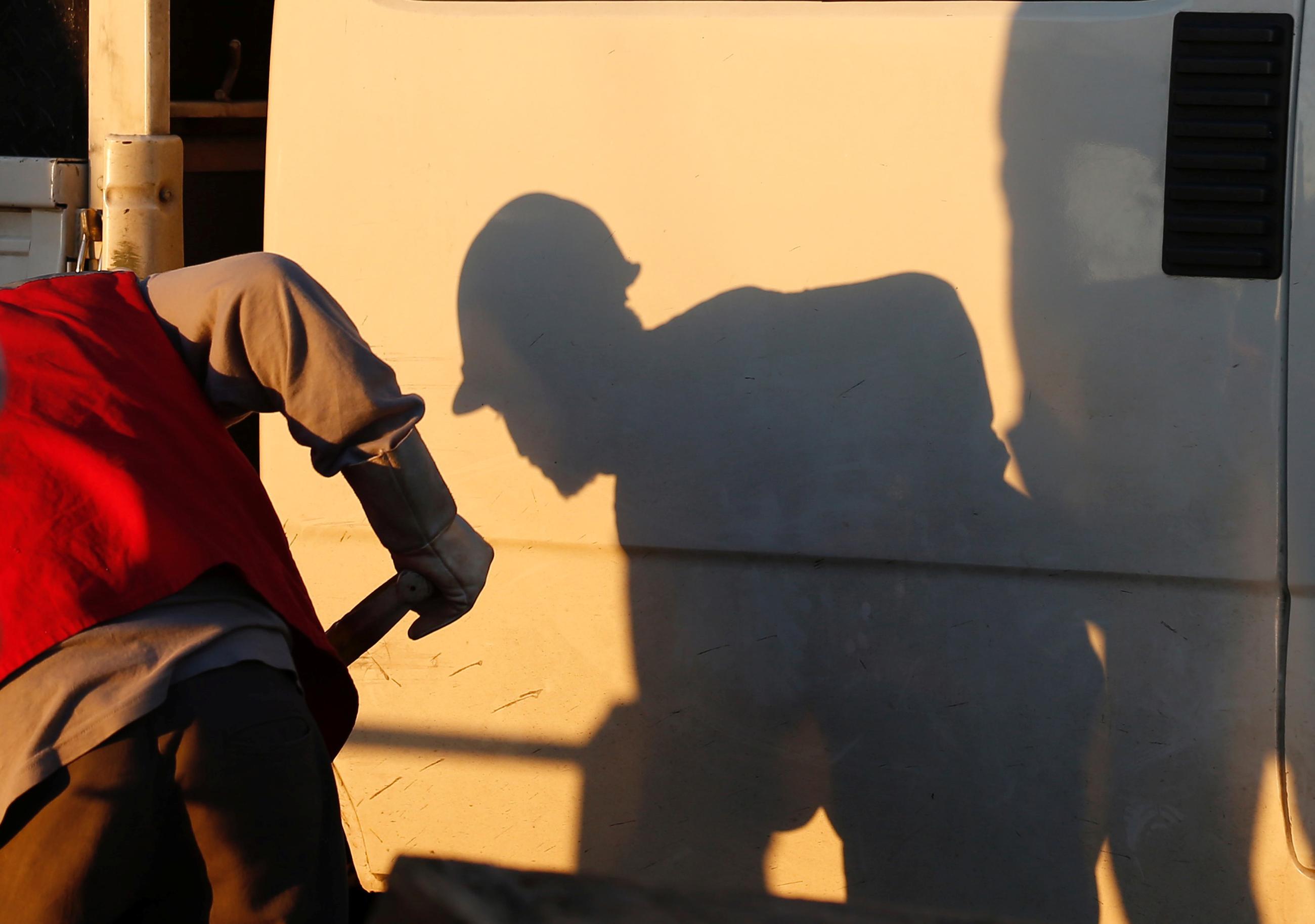 The shadow of a laborer working is seen at a construction site of a future urban project, in Valparaiso, Chile, on May 25, 2017. 