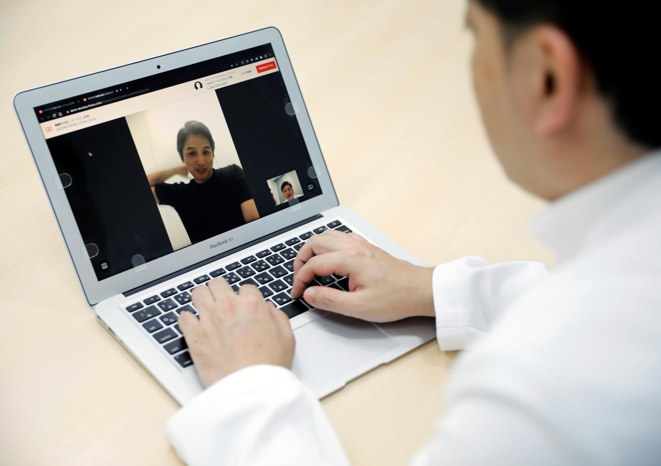 Makoto Kitada, MD, demonstrates a telemedicine application service called 'CLINICS', developed by Japanese medical start-up Medley Inc., in Tokyo, Japan, on July 8, 2020.