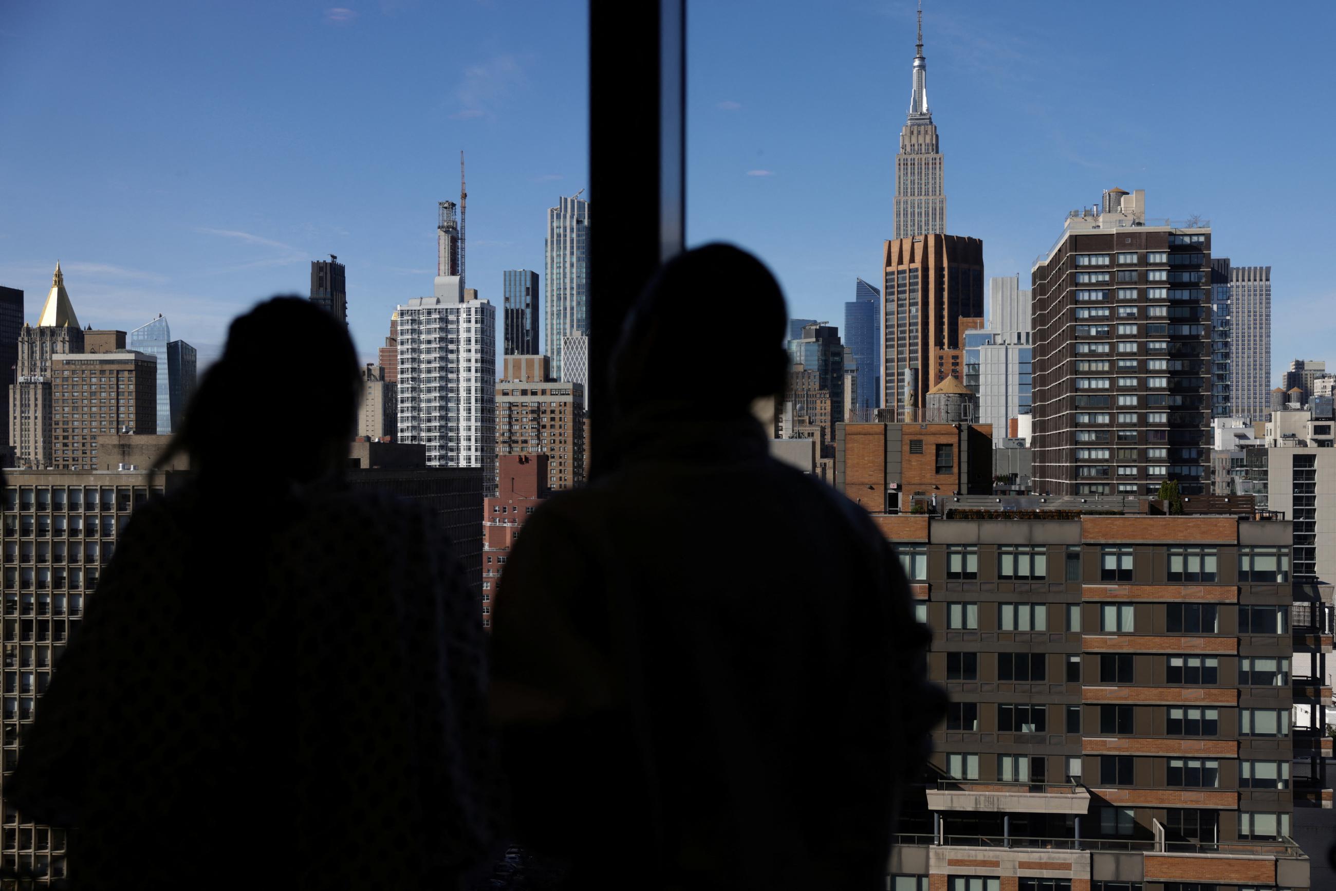 A woman who received the first fully robotic double lung transplant looks out the window with her nurse, at NYU Langone Health Center Transplant Institute, in New York City, on November 19, 2024.