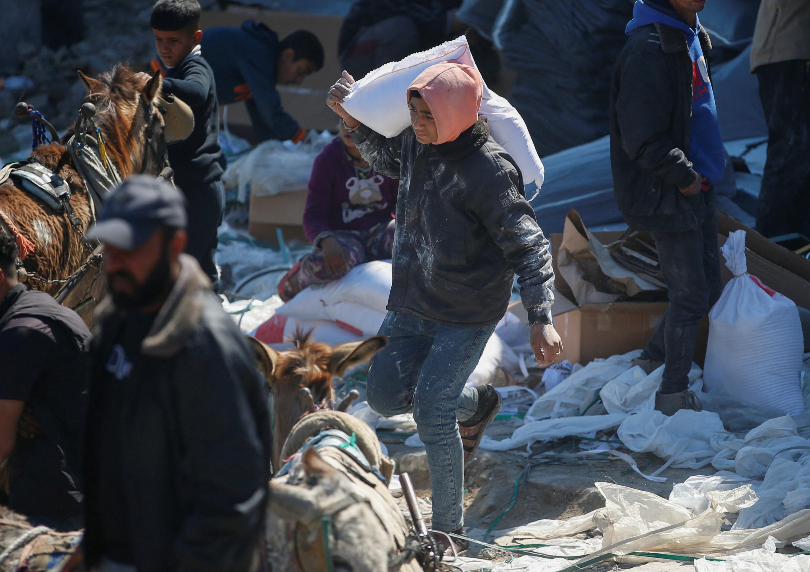 Palestinians gather to receive aid provided by UNRWA, after Israel halted the entry of humanitarian aid, outside a distribution center, at Jabalia refugee camp, Gaza Strip, on March 2, 2025.