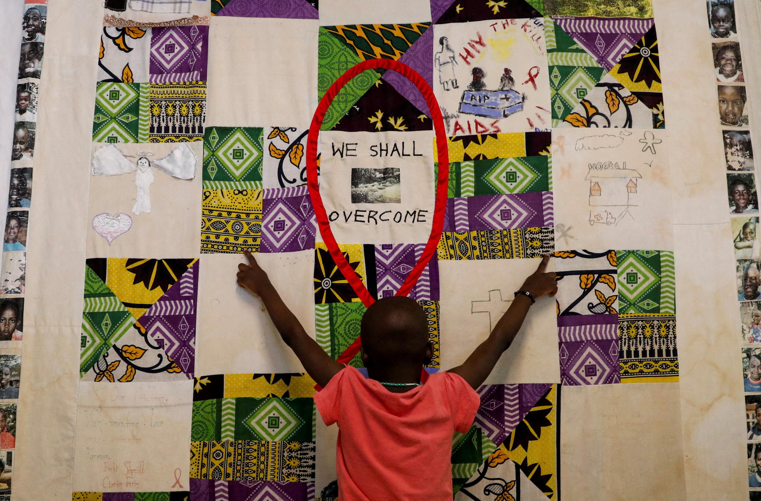 A child plays at an advocacy wall after receiving a dose of antiretroviral drugs used to prevent HIV from replicating, at the Nyumbani Children's Home, in Nairobi, Kenya, on February 12, 2025.