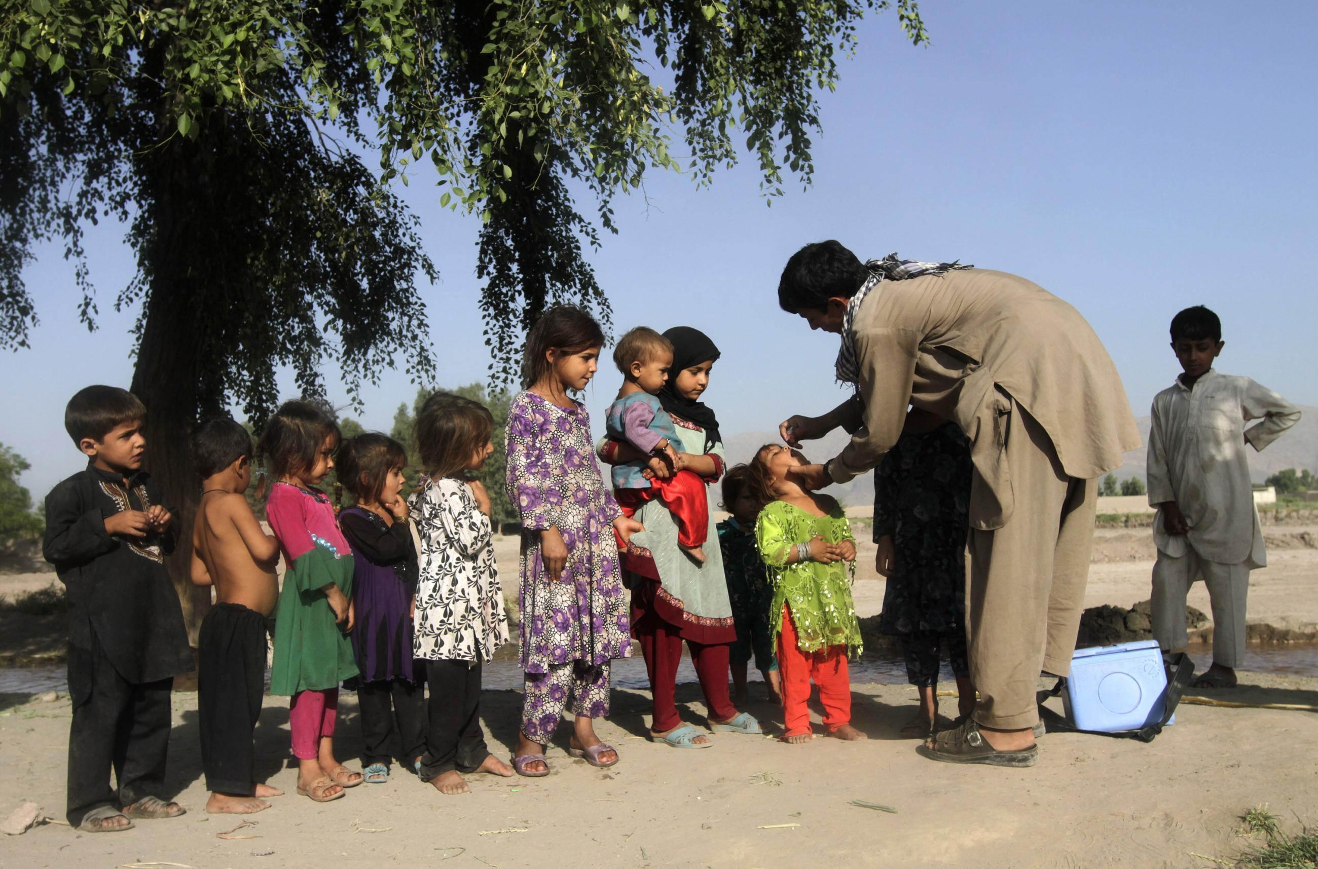 A girl receives a polio vaccination during a polio vaccination campaign, on the outskirts of Jalalabad, Afghanistan, on August 18, 2014. 