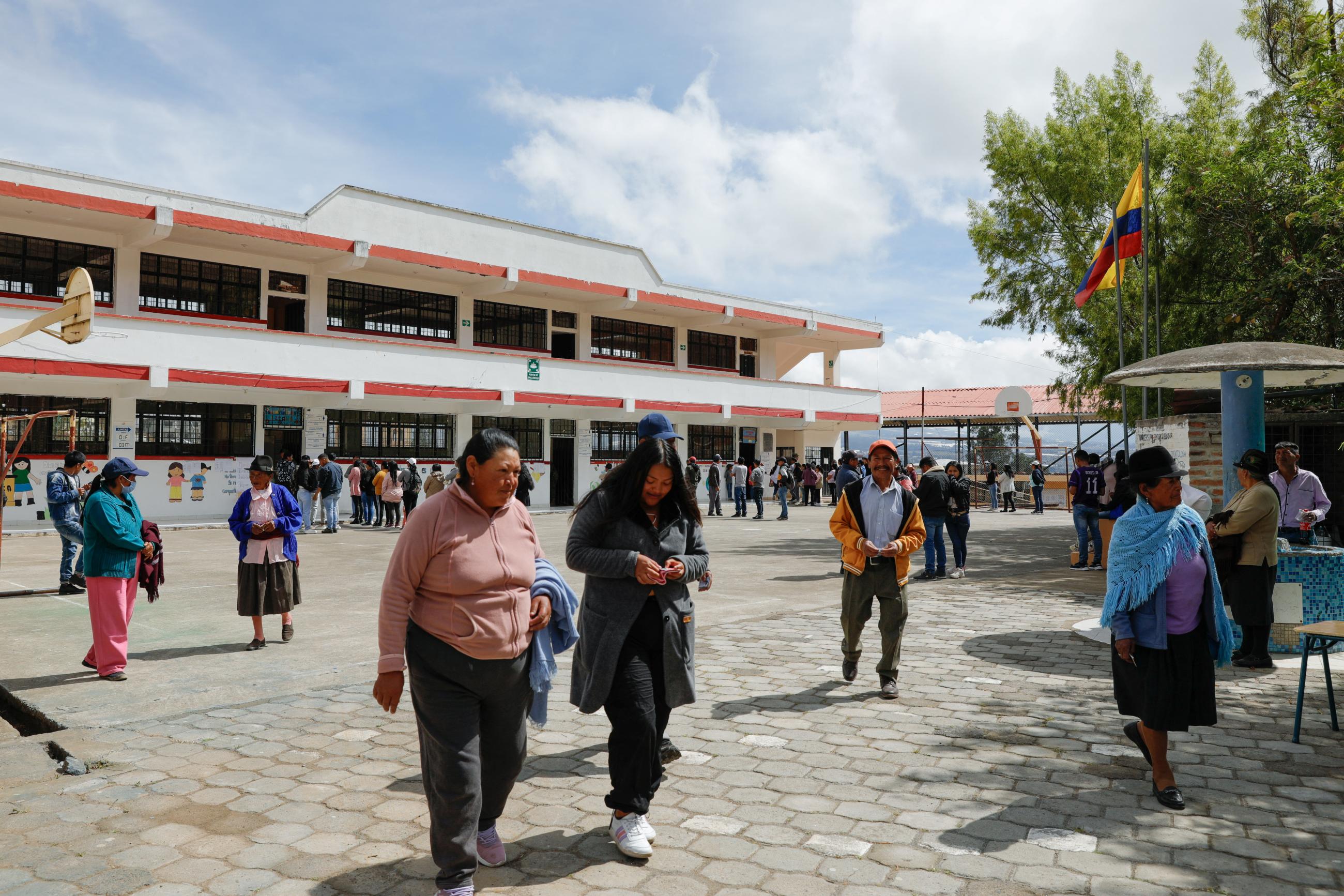 People leave after casting their votes at the Cesar Arroyo school during the presidential elections, in Cayambe, Ecuador, on August 20, 2023. 