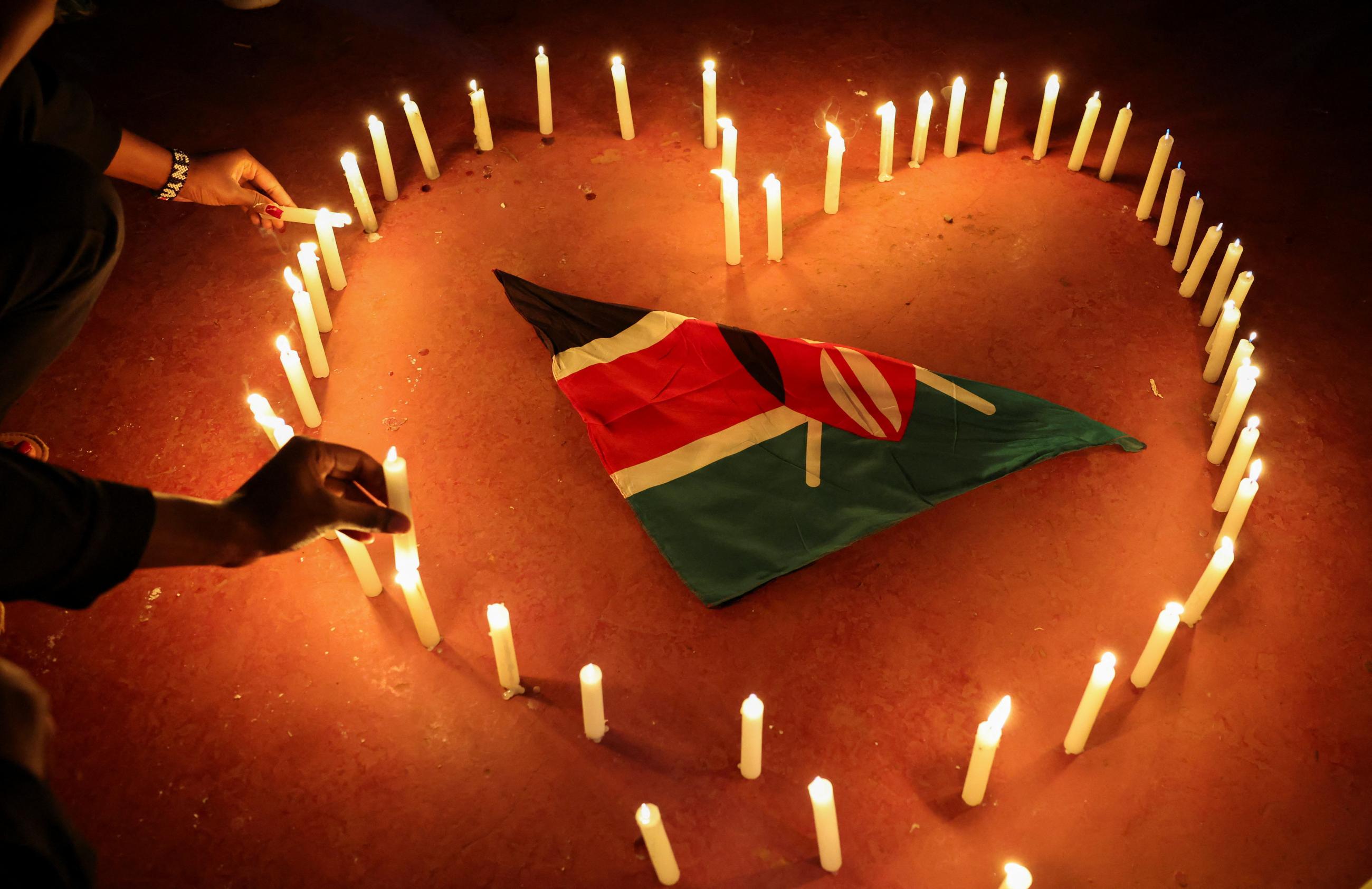 People participate in a vigil to raise awareness about gender-based violence and honor the lives of women lost to femicide in higher learning institutions, in Juja, Kenya, on April 11, 2025. 