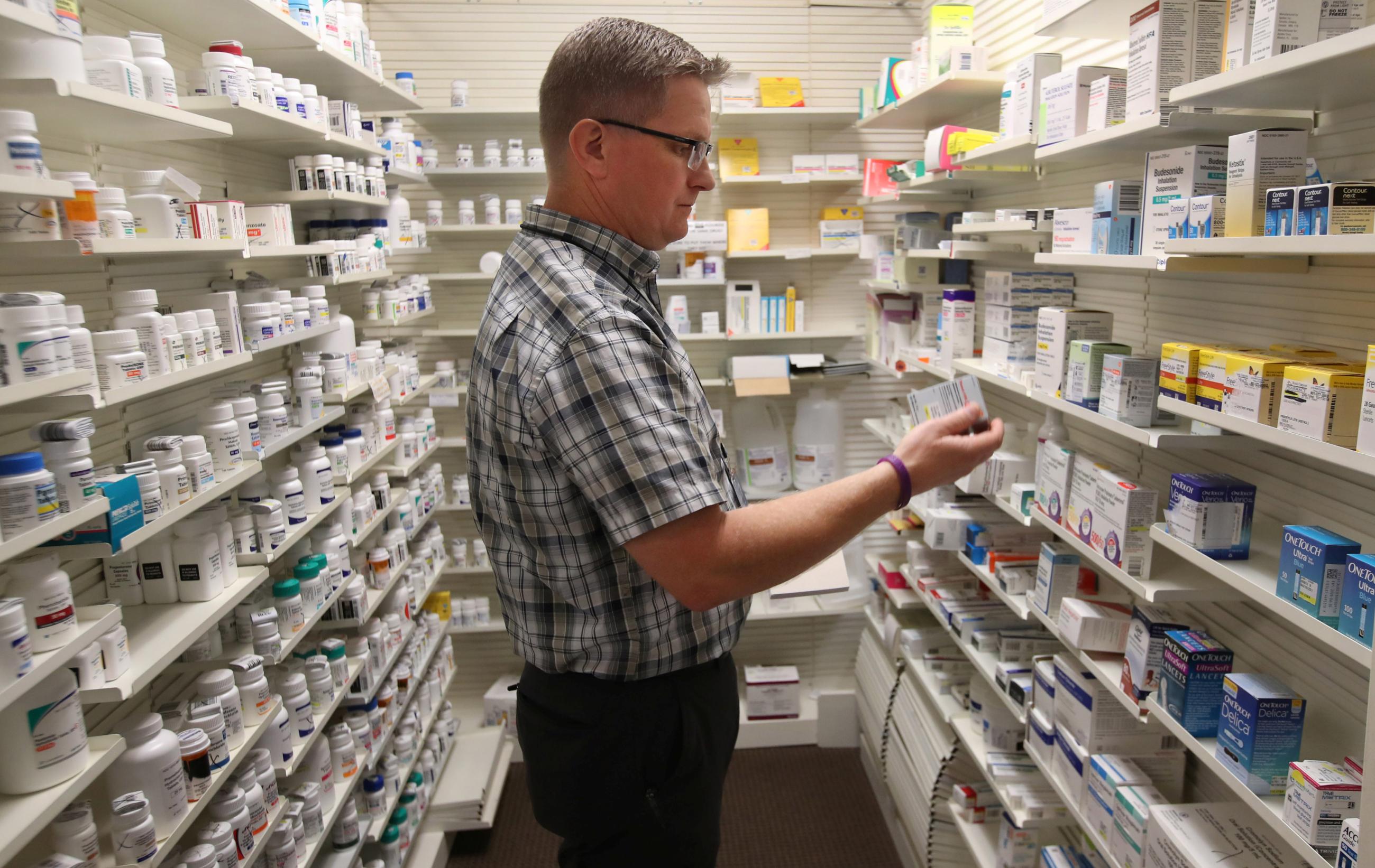Pharmacist Thomas Jensen looks over a prescription drug at the Rock Canyon pharmacy, in Provo, Utah, on May 9, 2019. 