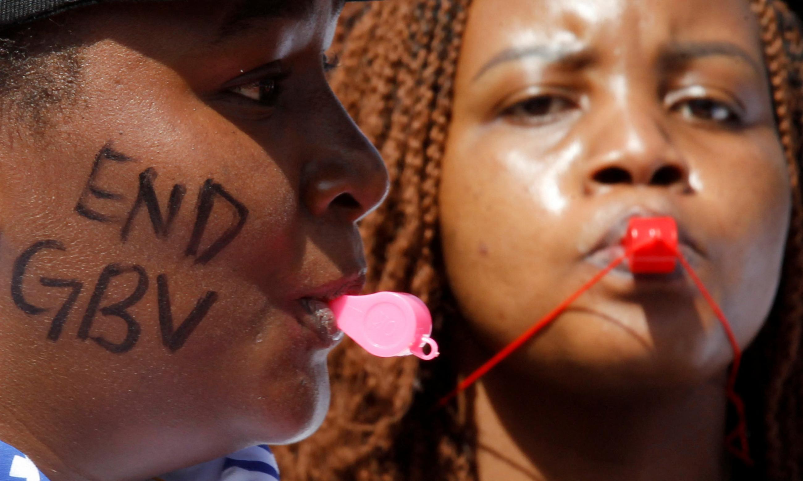 Members of the civil society blow whistles as they demonstrate against gender-based violence, in Nairobi, Kenya, on March 8, 2022. 