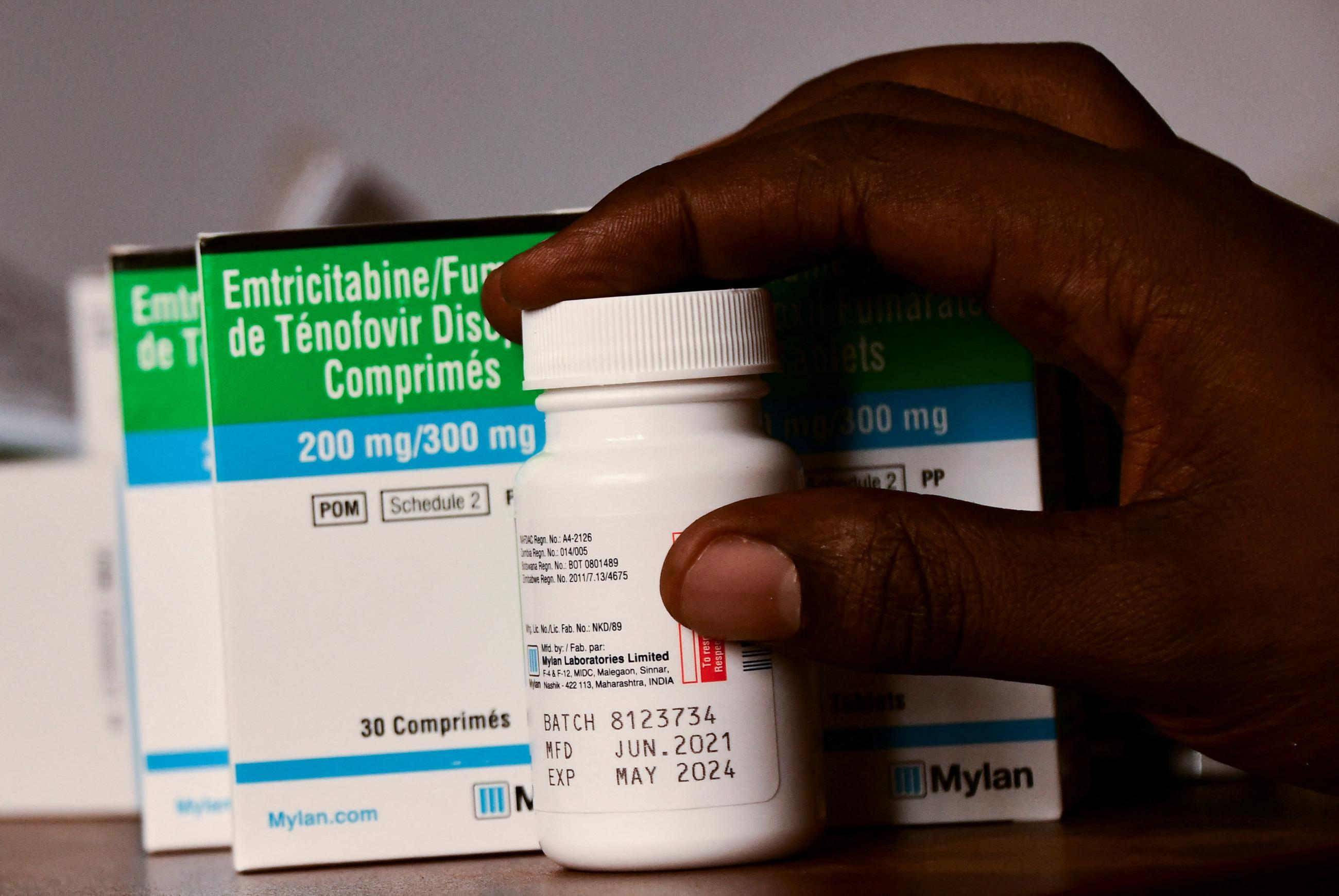 A medical clinic officer holds a package of medicine at the Ice Breakers Uganda clinic in Makindye that supports HIV/AIDS programs and treatment, in Kampala, Uganda, on June 1, 2023. 