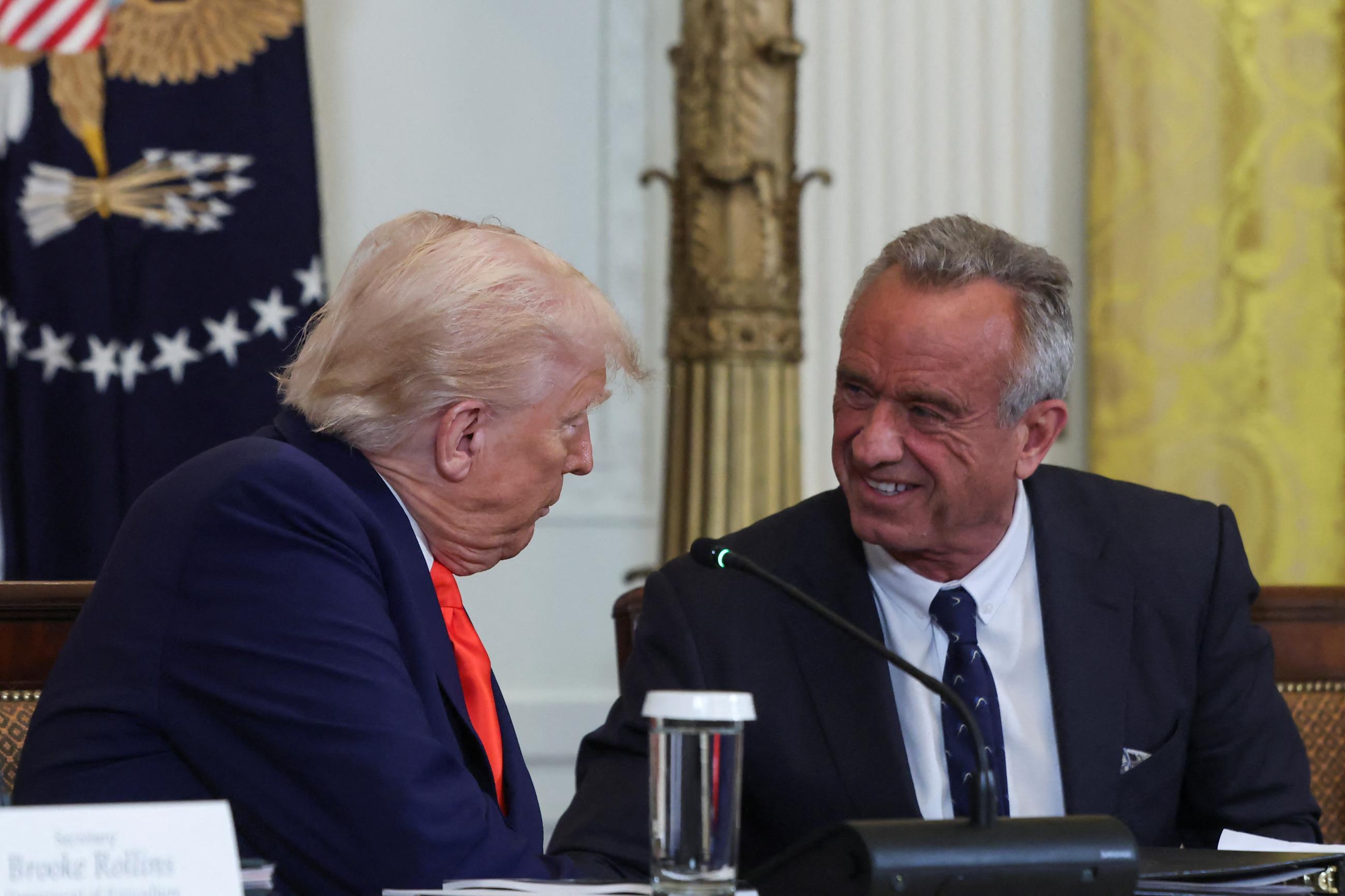 U.S. President Donald Trump speaks with Health and Human Services Secretary Robert F. Kennedy Jr. at a Make America Healthy Again Commission event, in Washington, DC, on May 22, 2025.