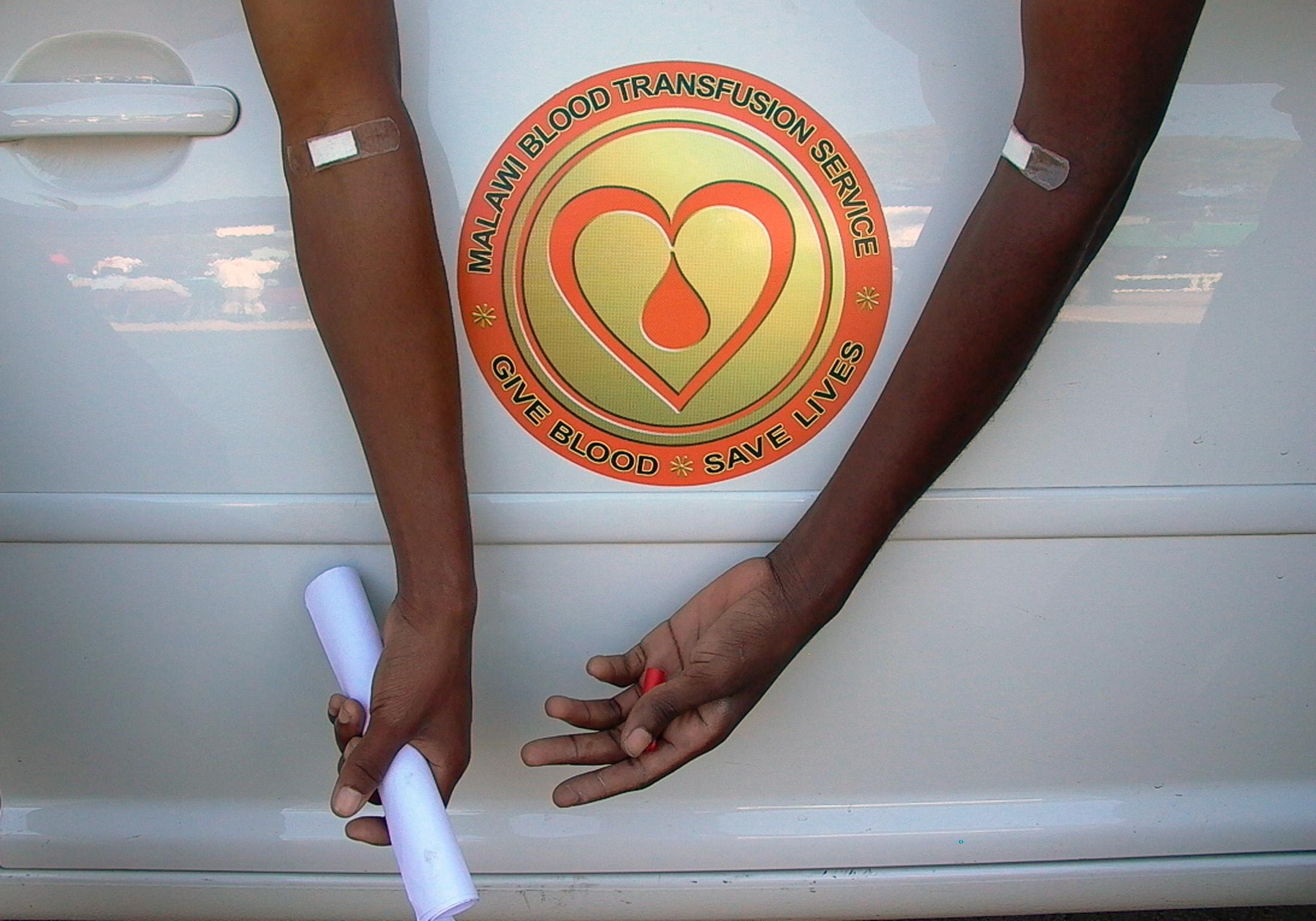Young Malawians leave a clinic after donating blood in Malawi's commercial center, in Blantyre, Malawi, on June 14, 2005.