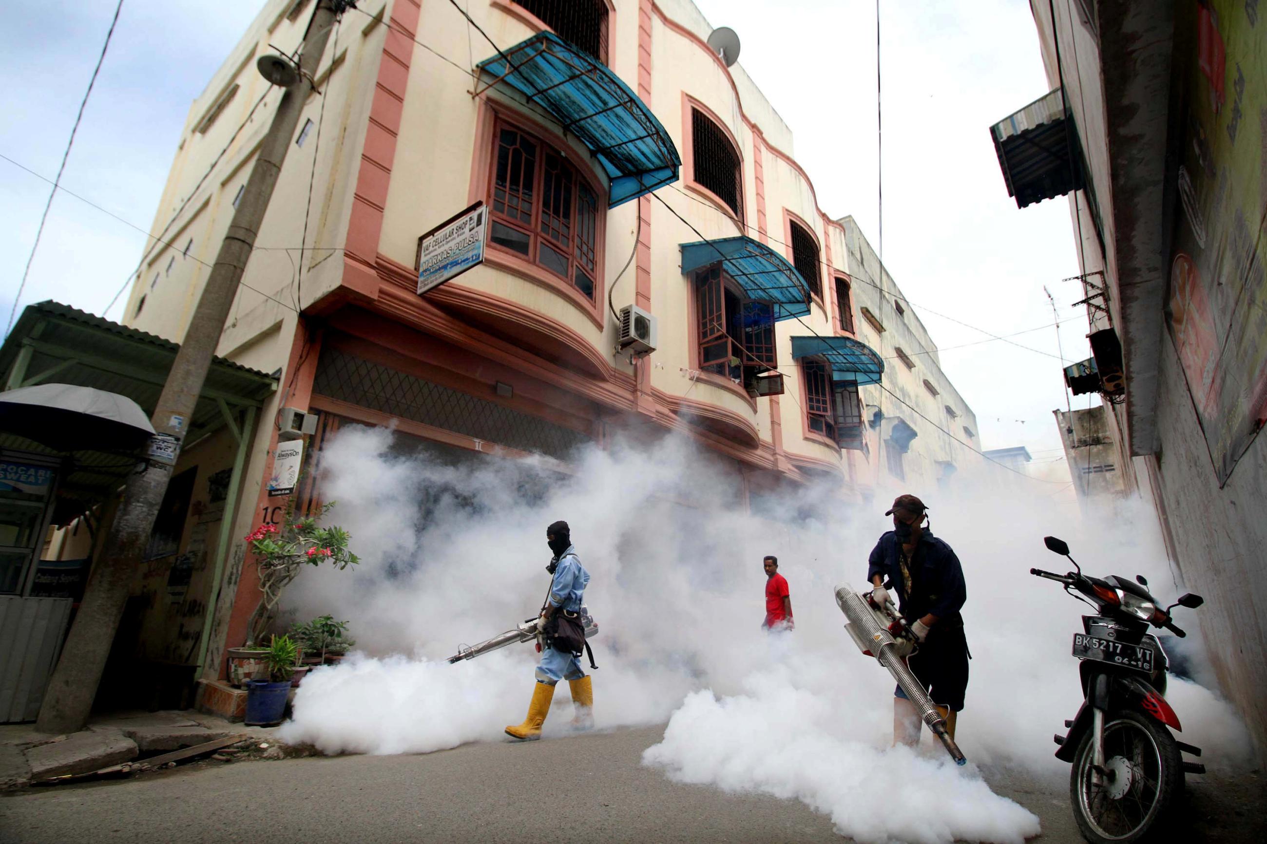 City officers conduct mosquito fogging, at a residential complex, in Lhokseumawe, Aceh province,  Indonesia, on October 26, 2016.