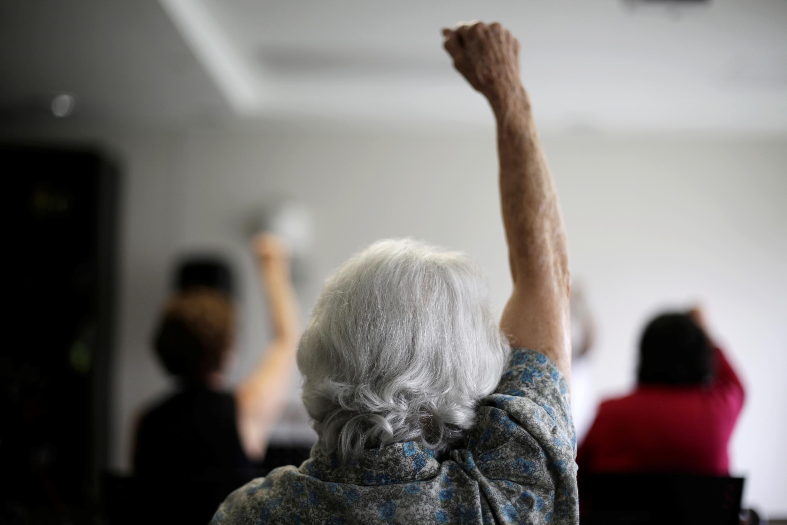 An elderly woman takes part in an exercise class, in San Jose, Costa Rica, on October 15, 2018. 