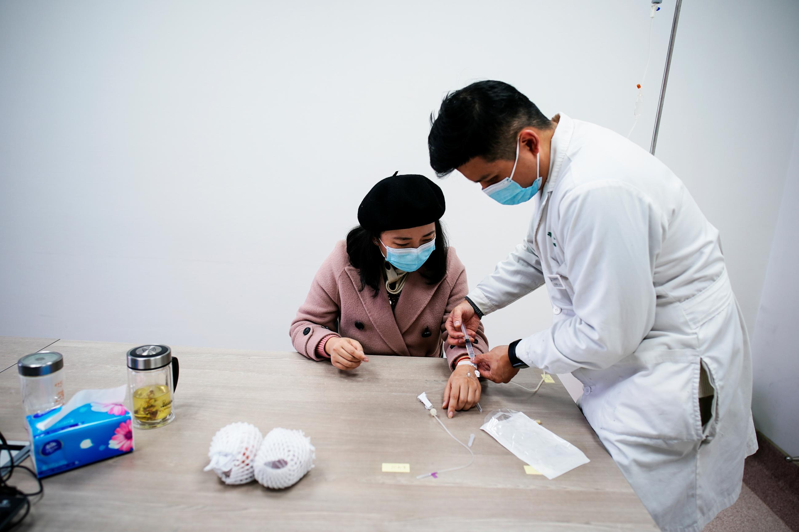 A woman receives medical treatment for in-vitro fertilization at a hospital, in Wuhan, Hubei province, China, on December 16, 2020.