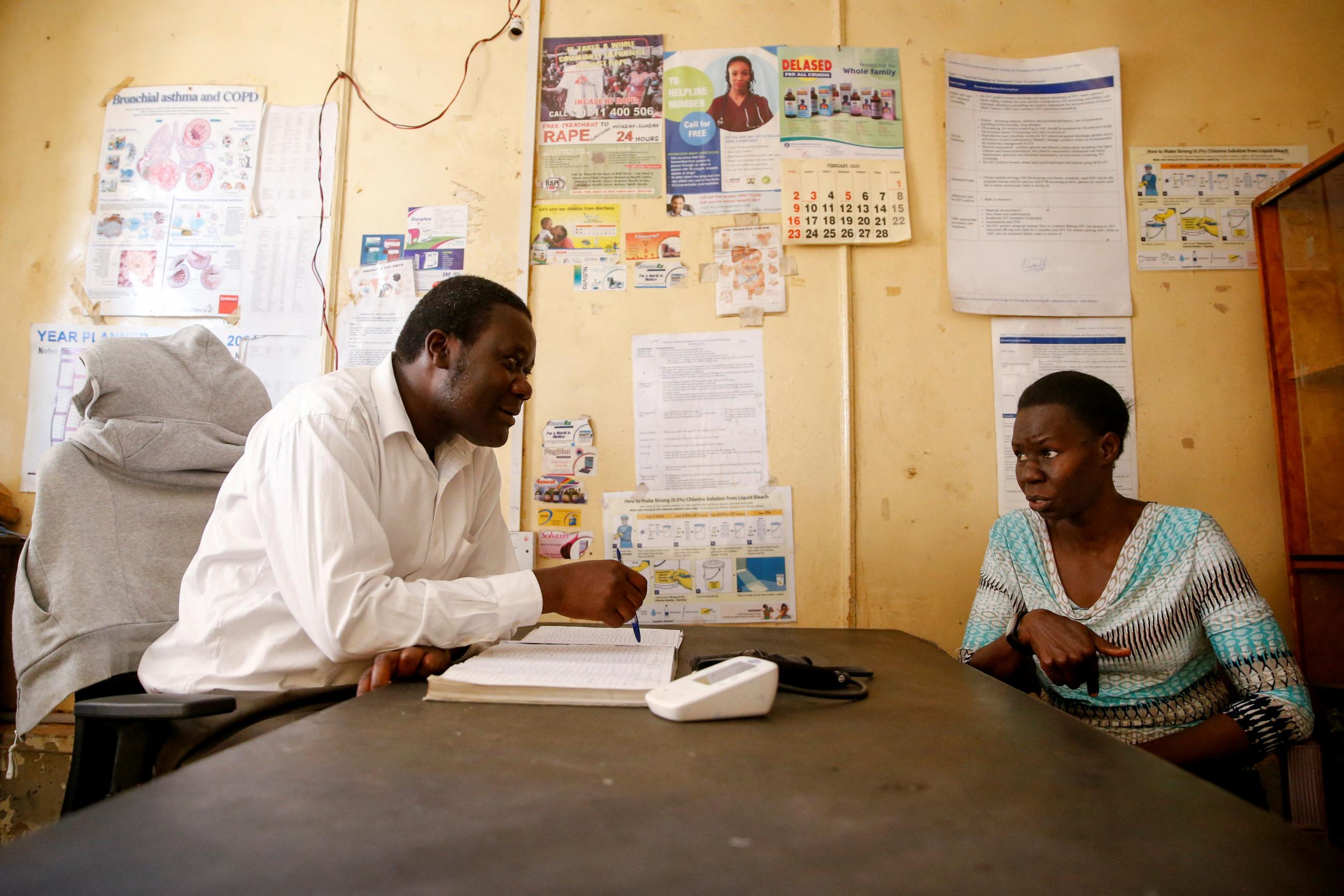 A widow living with HIV/AIDS, speaks with the administrator at the Ushirika Medical Clinic and Maternity Services, in Nairobi, Kenya, on February 28, 2025.