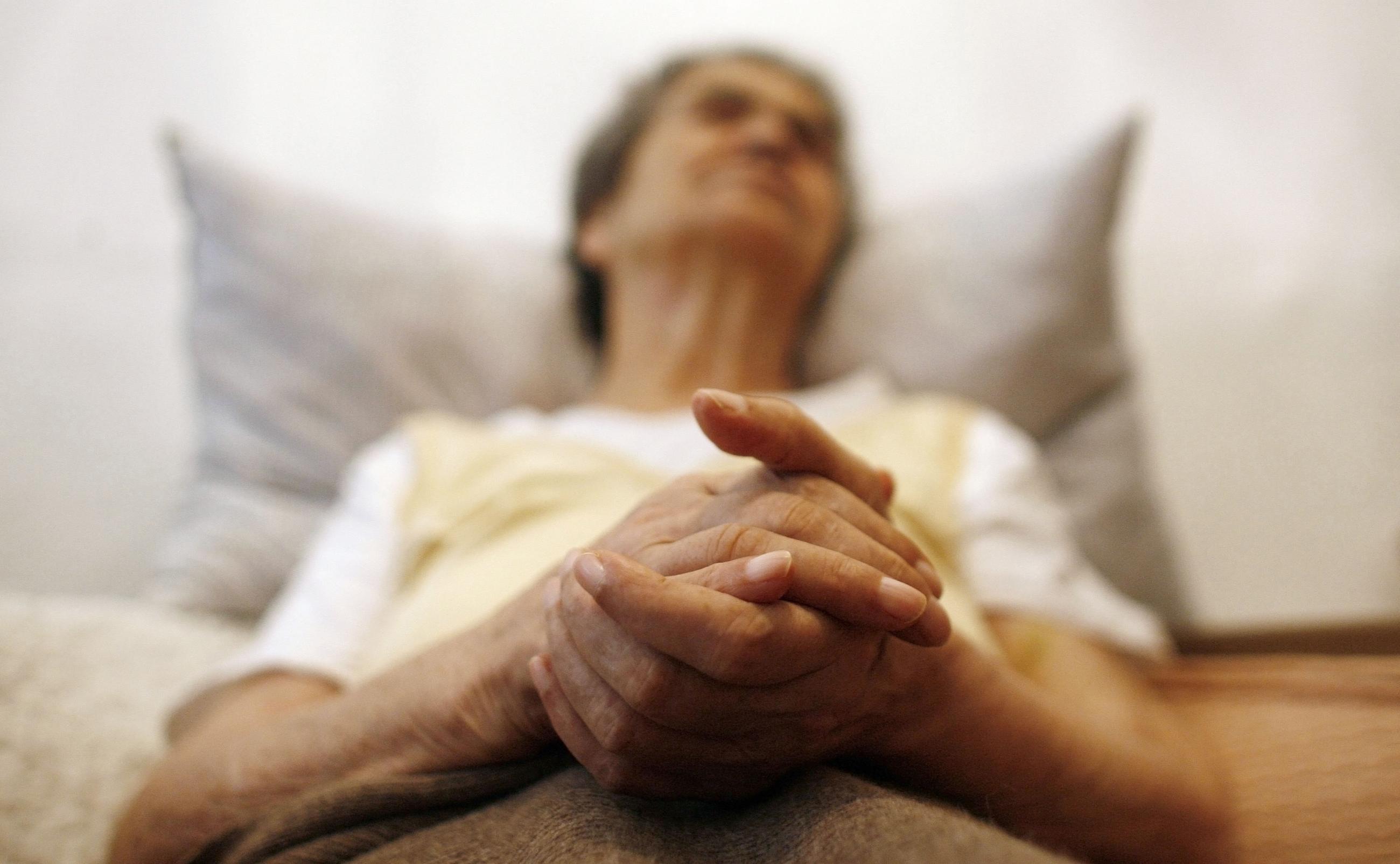 Alzheimer's disease patient Isidora Tomaz sits in an armchair in her house, in Lisbon, Portugal, on September 15, 2009.
