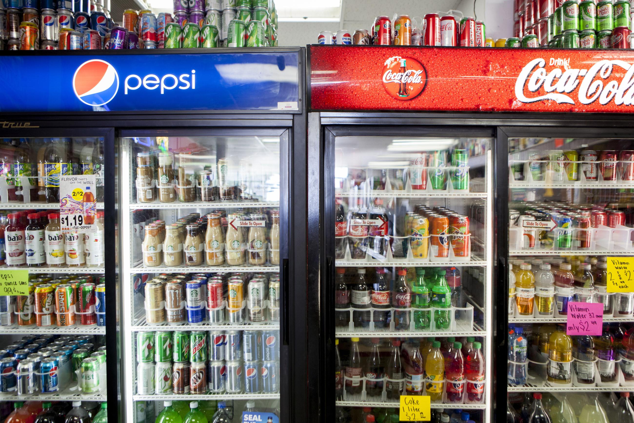 Cans of soda are displayed in a case at Kwik Stops Liquor in San Diego, California, on February 13, 2014.