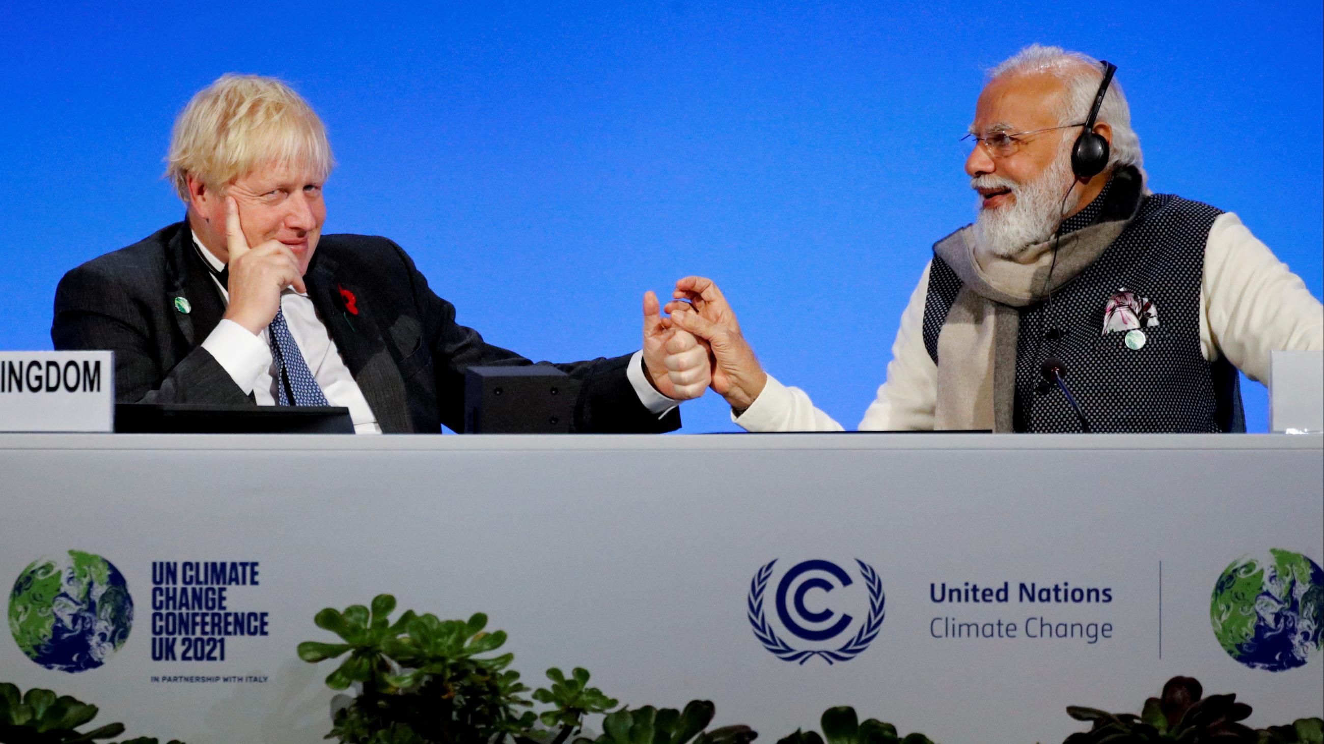 Britain's Prime Minister Boris Johnson and India's Prime Minister Narendra Modi attend a meeting during the UN Climate Change Conference (COP26) in Glasgow, Scotland, Britain, November 2, 2021. 