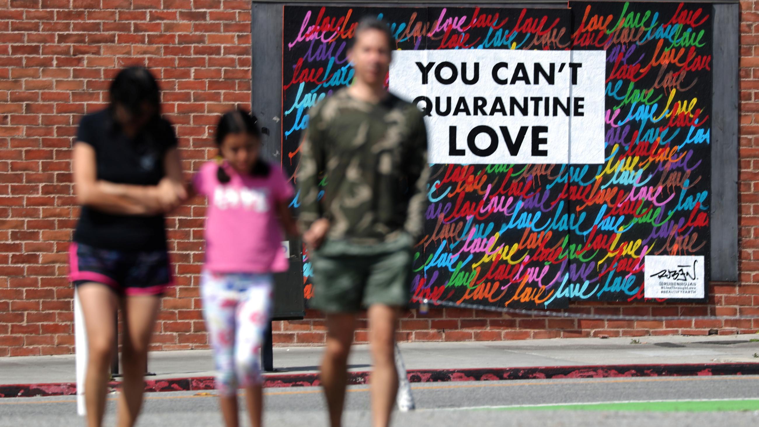 As the COVID-19 pandemic rages on in the United States, street art in Santa Monica, California, sends a message of hope, "you can't quarantine love," on May 11, 2020.