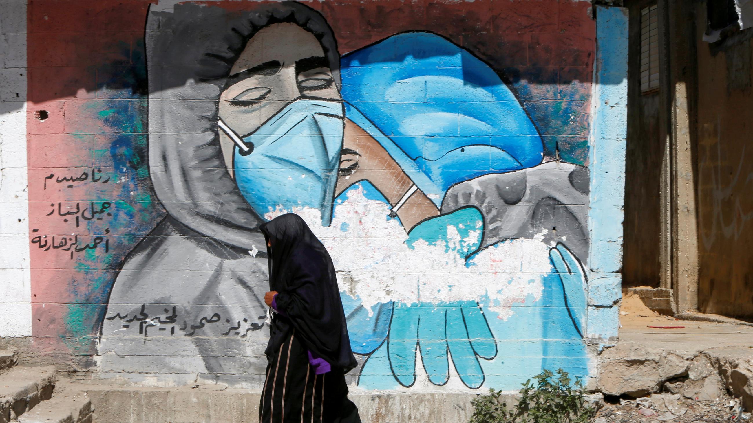 An emotional image graces a crumbling wall in the central Gaza Strip, on March 17, 2021. 