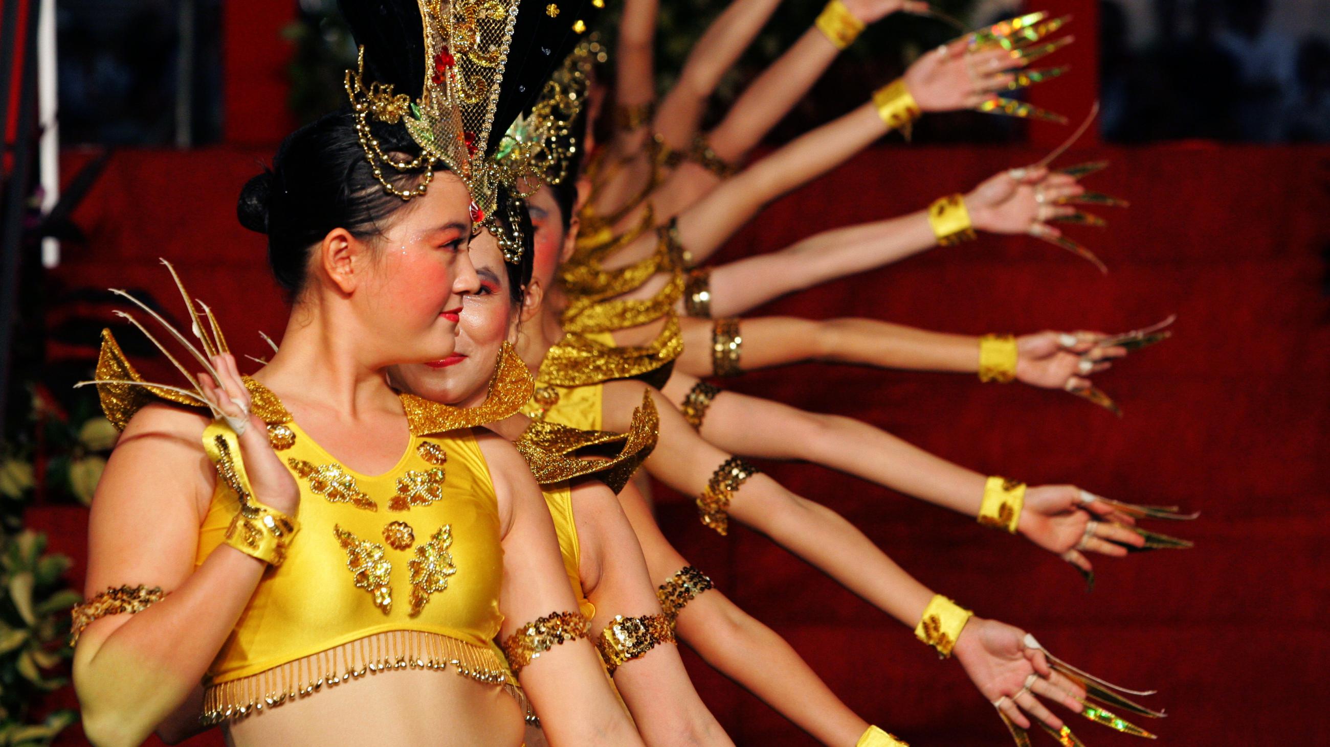 Performers dance during the opening ceremony of the Chinatown Mid-Autumn Festival 2005 in Singapore September 4, 2005.