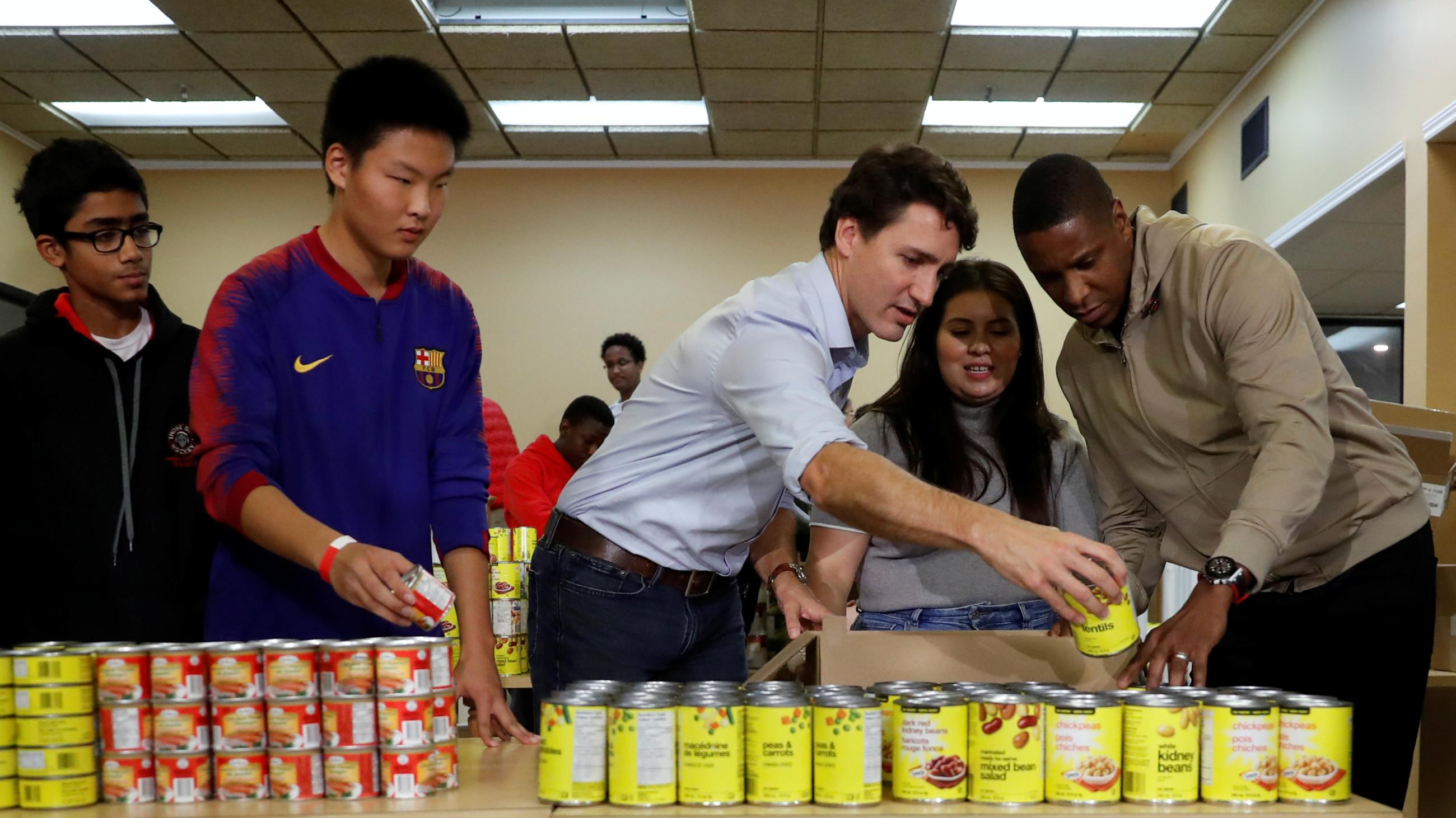 Canadian Prime Minister Justin Trudeau and Toronto Raptors President Masai Ujiri take part in a Thanksgiving food drive in Toronto, Ontario, Canada, on October 13, 2019.