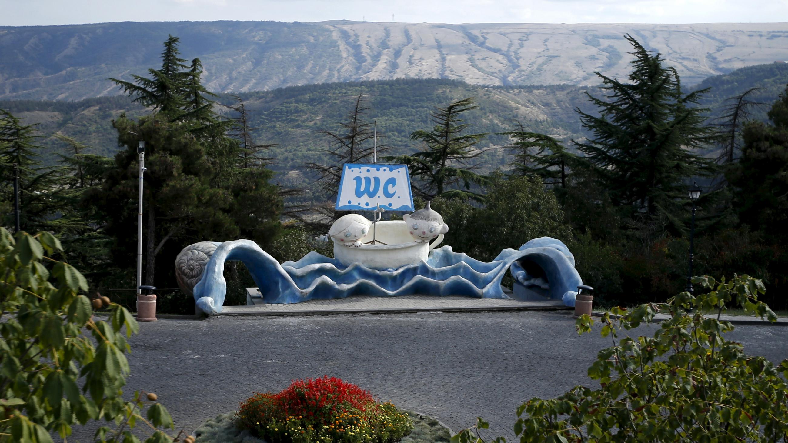 A public toilet with a sculpture of a young boy and girl is seen in Tbilisi, Georgia, on September 18, 2015.