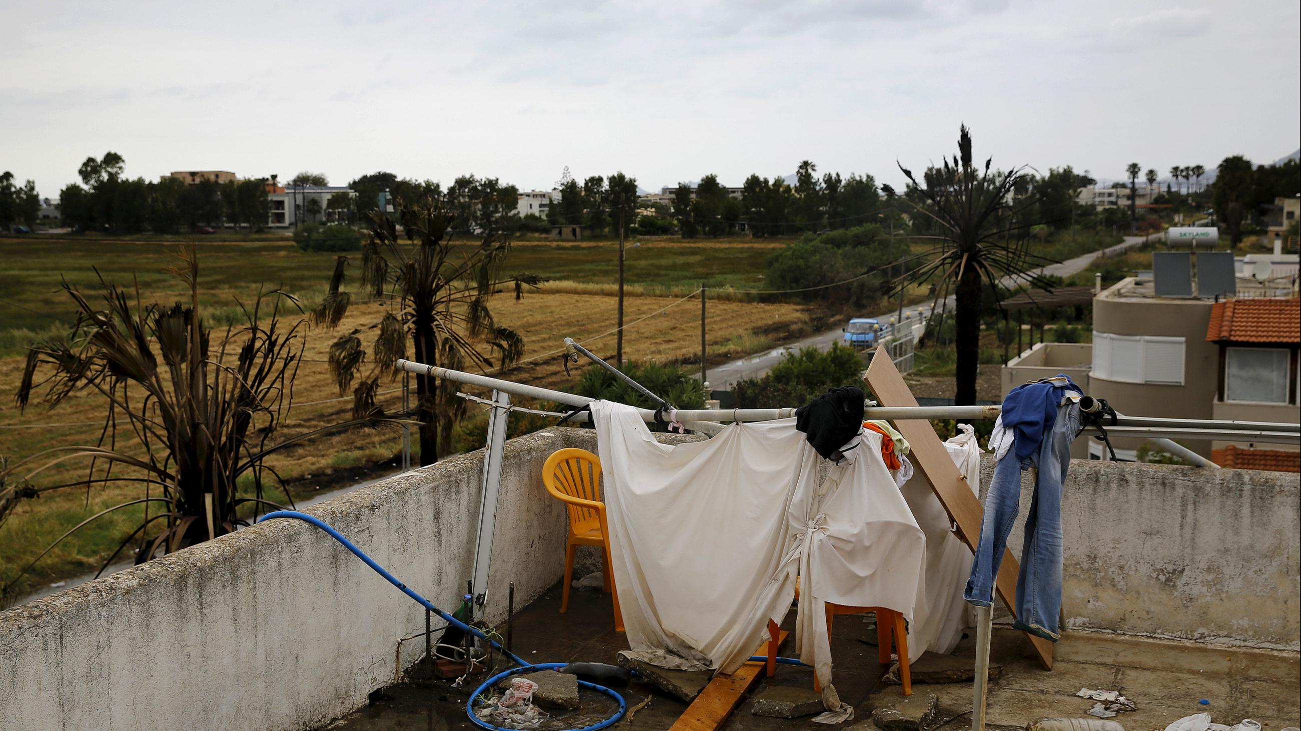 A makeshift shower cabin and toilet are seen atop a deserted hotel, where hundreds of migrants found temporary shelter on the Greek island of Kos, Greece, May 27, 2015.