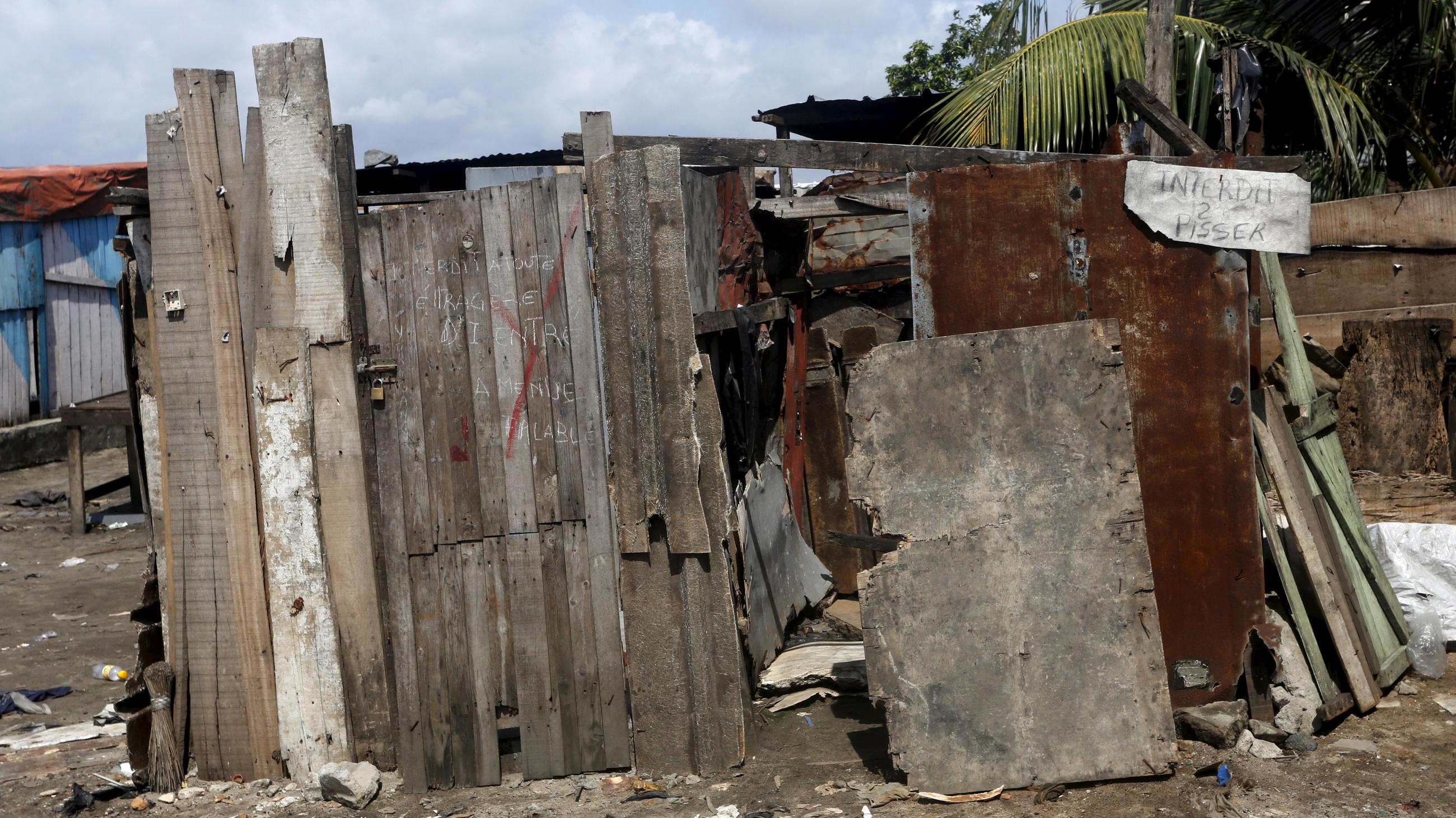 An outdoor toilet is seen with a sign that reads, "Pissing prohibited," in the Marcory district of Abidjan, Ivory Coast, on October 13, 2015. 