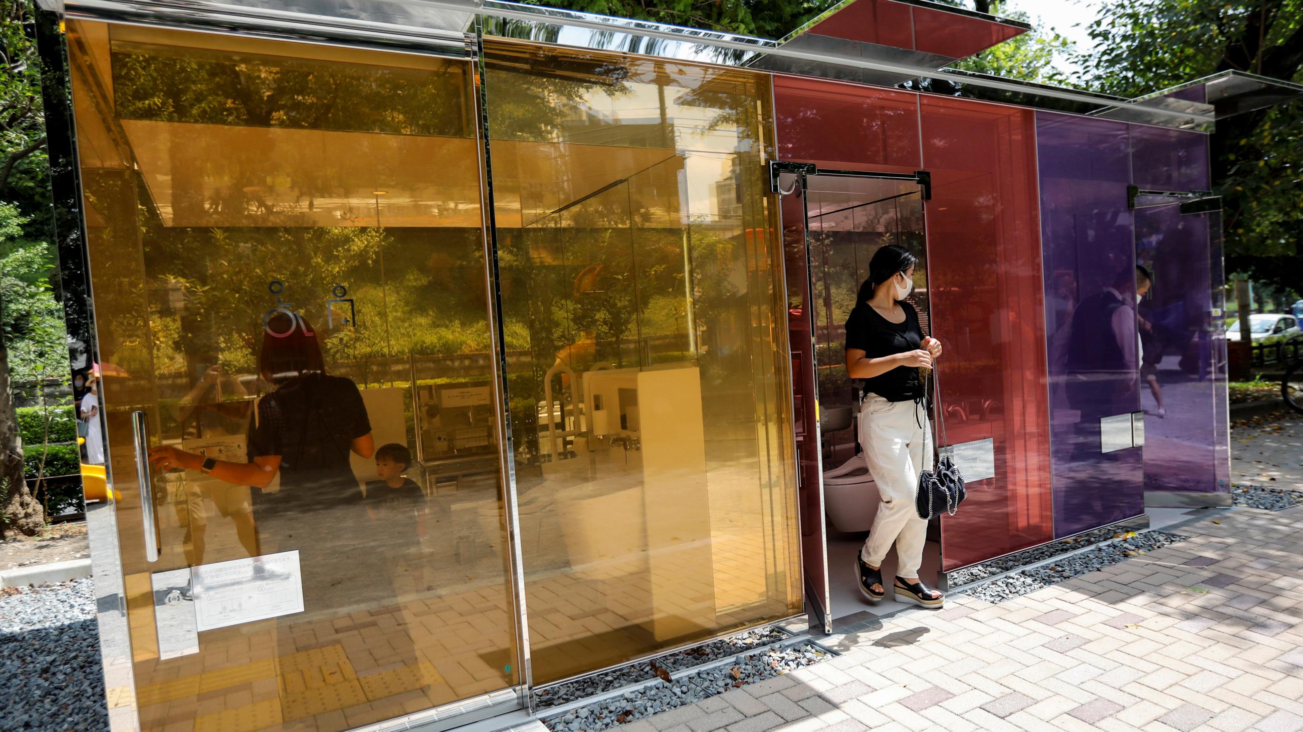 Visitors try out the transparent public toilets that become opaque when occupied, designed by Japanese architect Shigeru Ban, at Yoyogi Fukamachi Mini Park in Tokyo, Japan August 26, 2020.