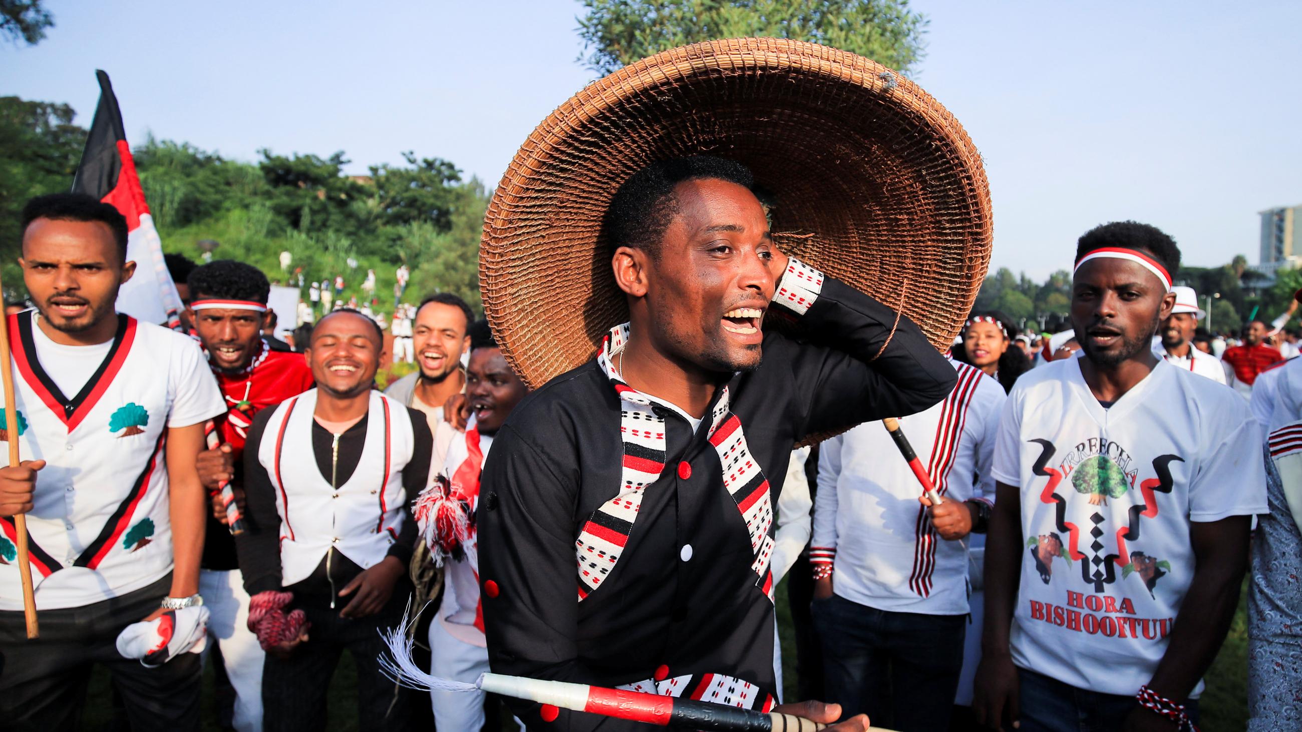 People dance during Irreechaa Festival, the Oromo People thanksgiving ceremony at the Hora Finfinnee, in Addis Ababa, Ethiopia, on October 2, 2021.