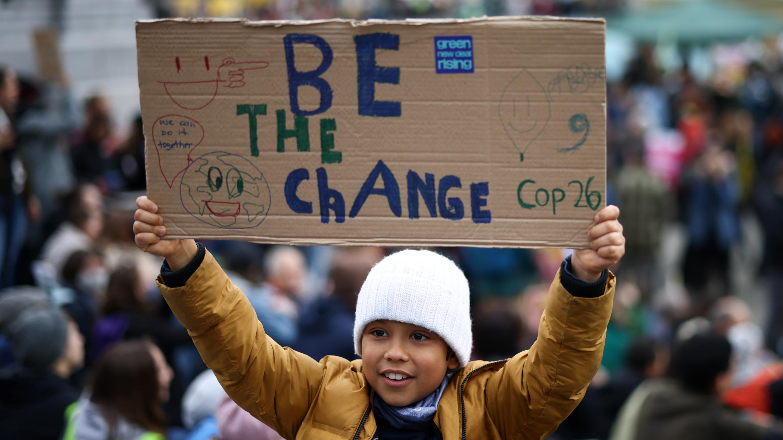 In many cities around the world, climate activists marched to send a message to decision-makers in Glasgow. At a London protest, a child holds a banner on November 6, 2021.