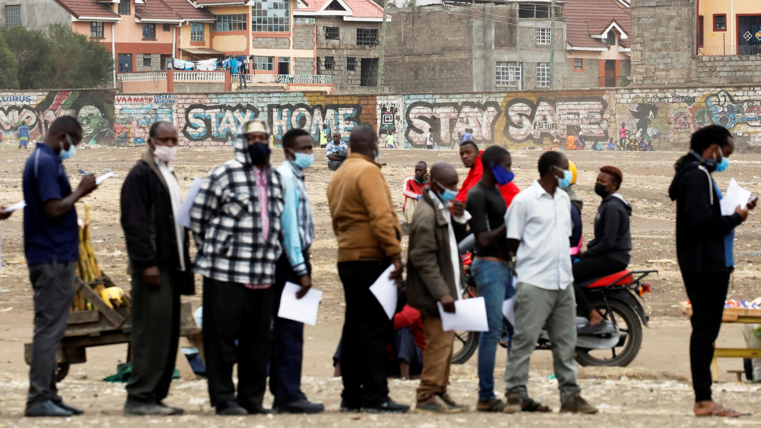 People wait in line to receive the AstraZeneca/Oxford COVID-19 vaccine, donated to Kenya by the UK government, in Nairobi, Kenya, August 8, 2021