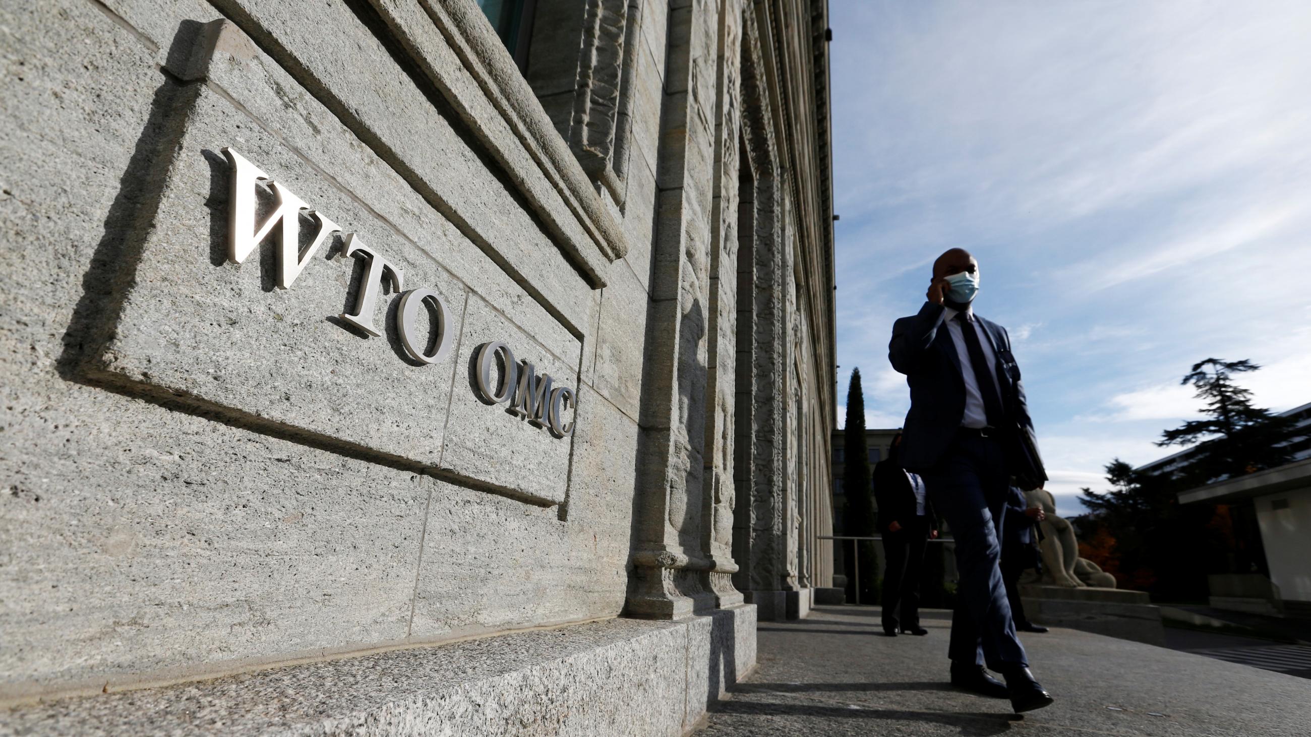 A delegate arrives before a meeting at the World Trade Organization in Geneva, Switzerland on October 28, 2020.