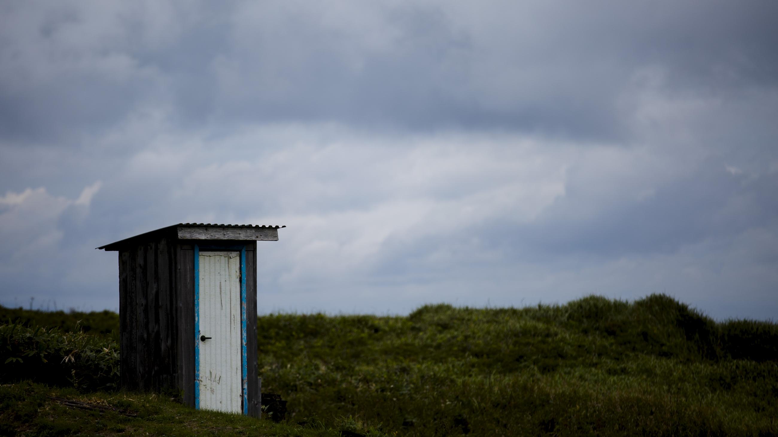 A toilet stands in a field on private property in the town of Yuzhno-Kurilsk on Kunashir Island which is part of the Kuril Islands group in Russia, September 16, 2015