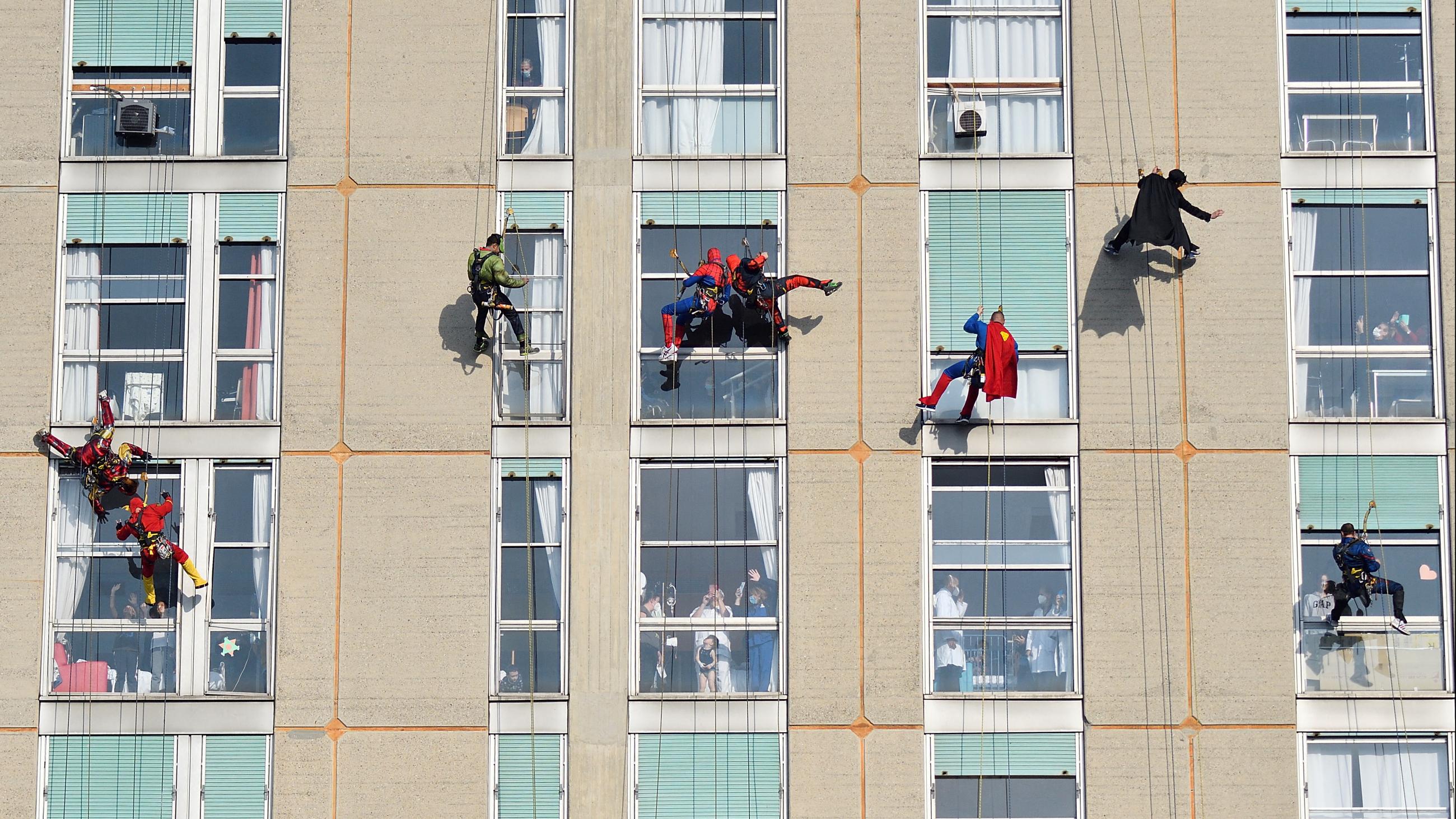 Acrobats dressed as superheroes greeted children outside their windows in the pediatric ward of the San Paolo Hospital in Milan, Italy.