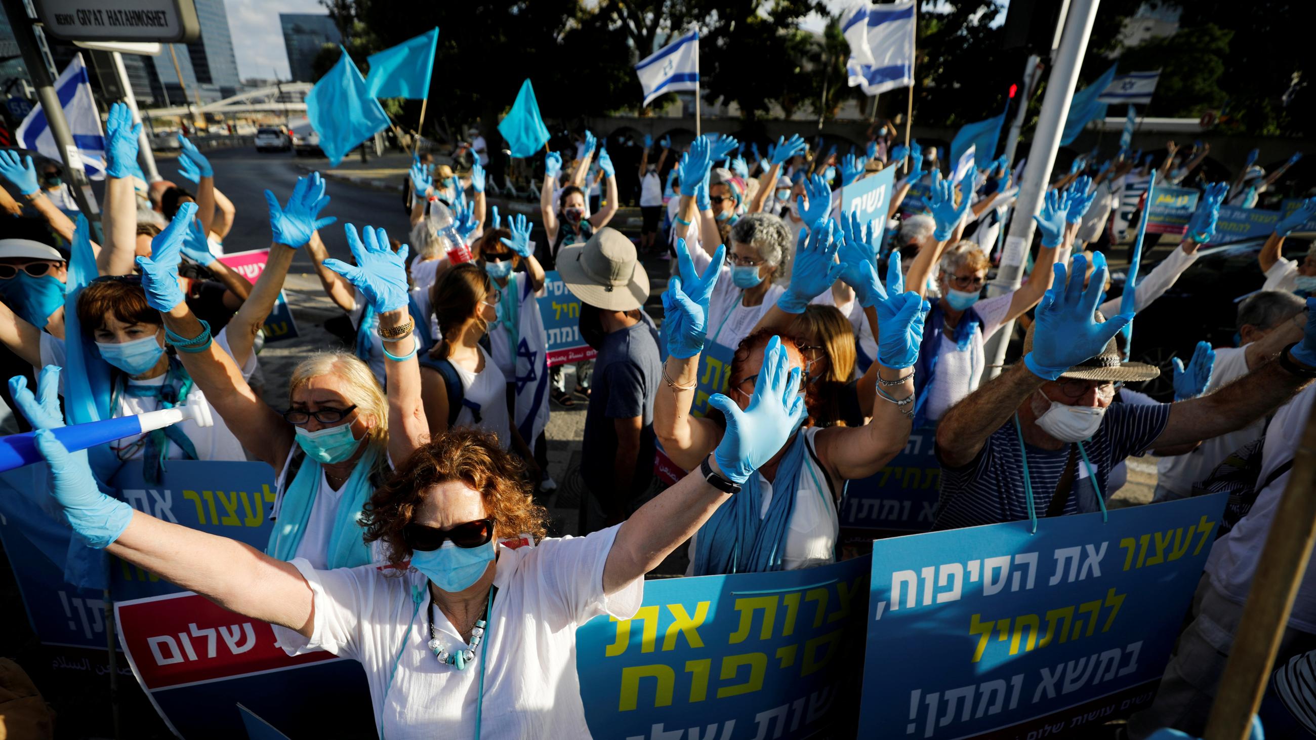 Women take part in a protest, organized by the "Women Wage Peace" grassroots movement, against Israel's planned annexation of part of the Israeli-occupied West Bank, outside government offices in Tel Aviv, Israel, on June 18, 2020