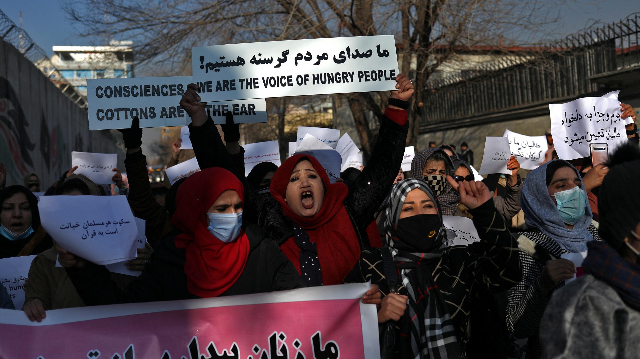 Afghan women shout slogans during a rally to protest against what the protesters say is Taliban restrictions on wome