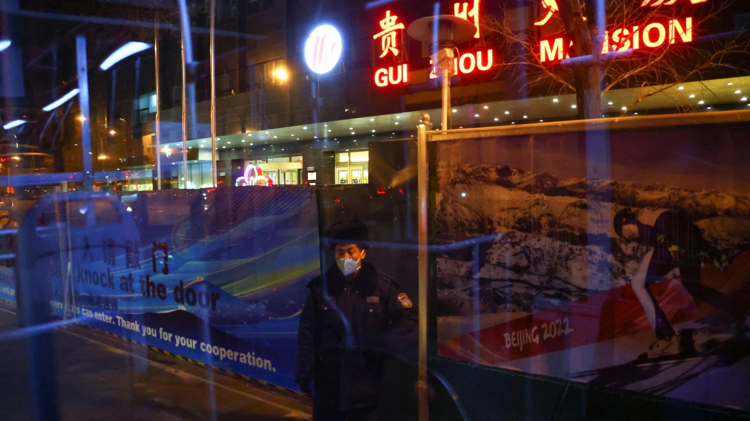 A security guard stands at the entrance of a media hotel inside a closed loop area designed to prevent the spread of the coronavirus disease (COVID-19) ahead of the Beijing 2022 Winter Olympics in Beijing, China January 26, 2022.