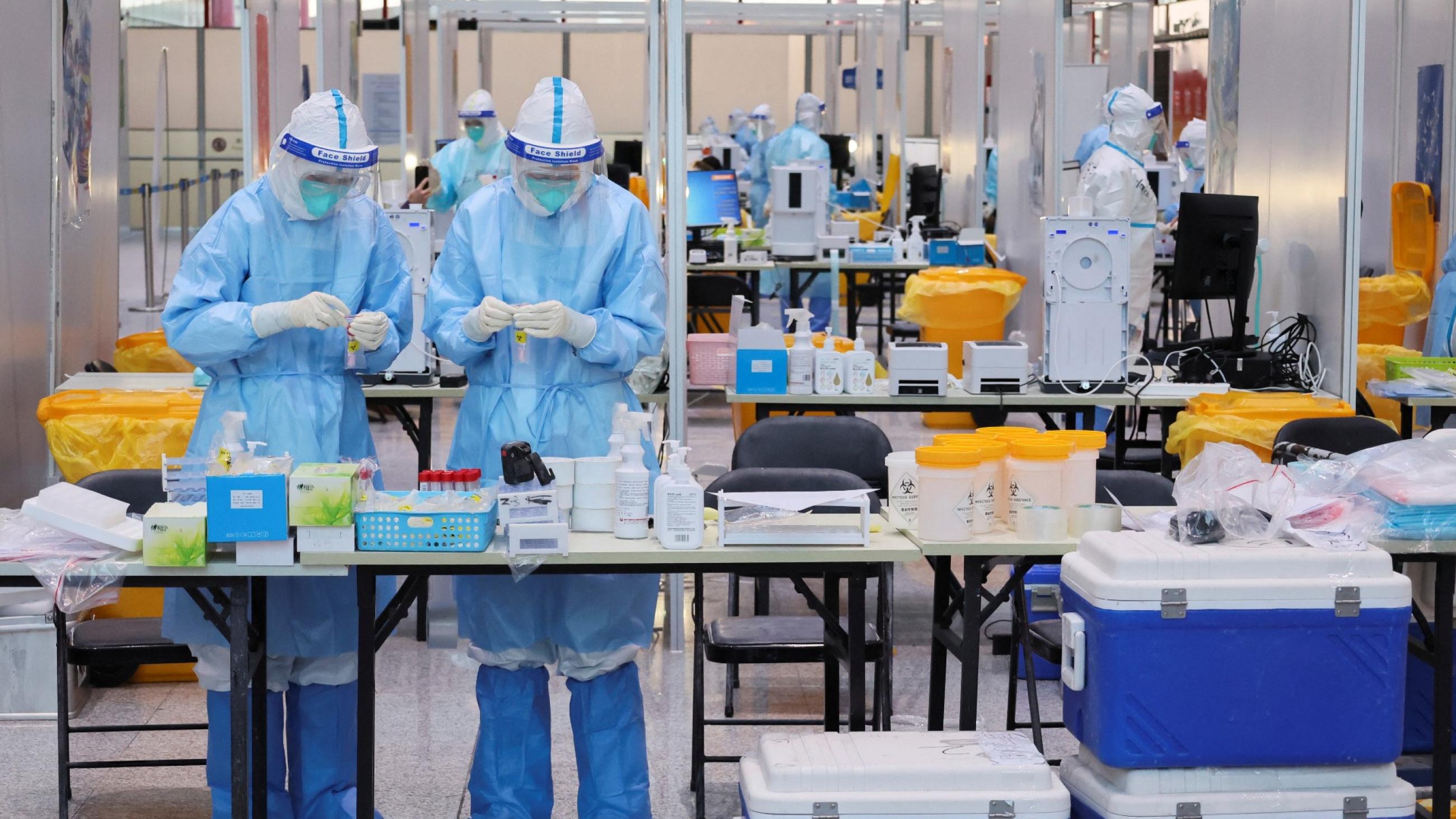 Medical workers wearing personal protective equipment (PPE), designed to prevent the spread of the coronavirus disease (COVID-19), work at a COVID-19 testing site at Beijing Capital International Airport ahead of the Beijing 2022 Winter Olympics in Beijing, China January 31, 2022.