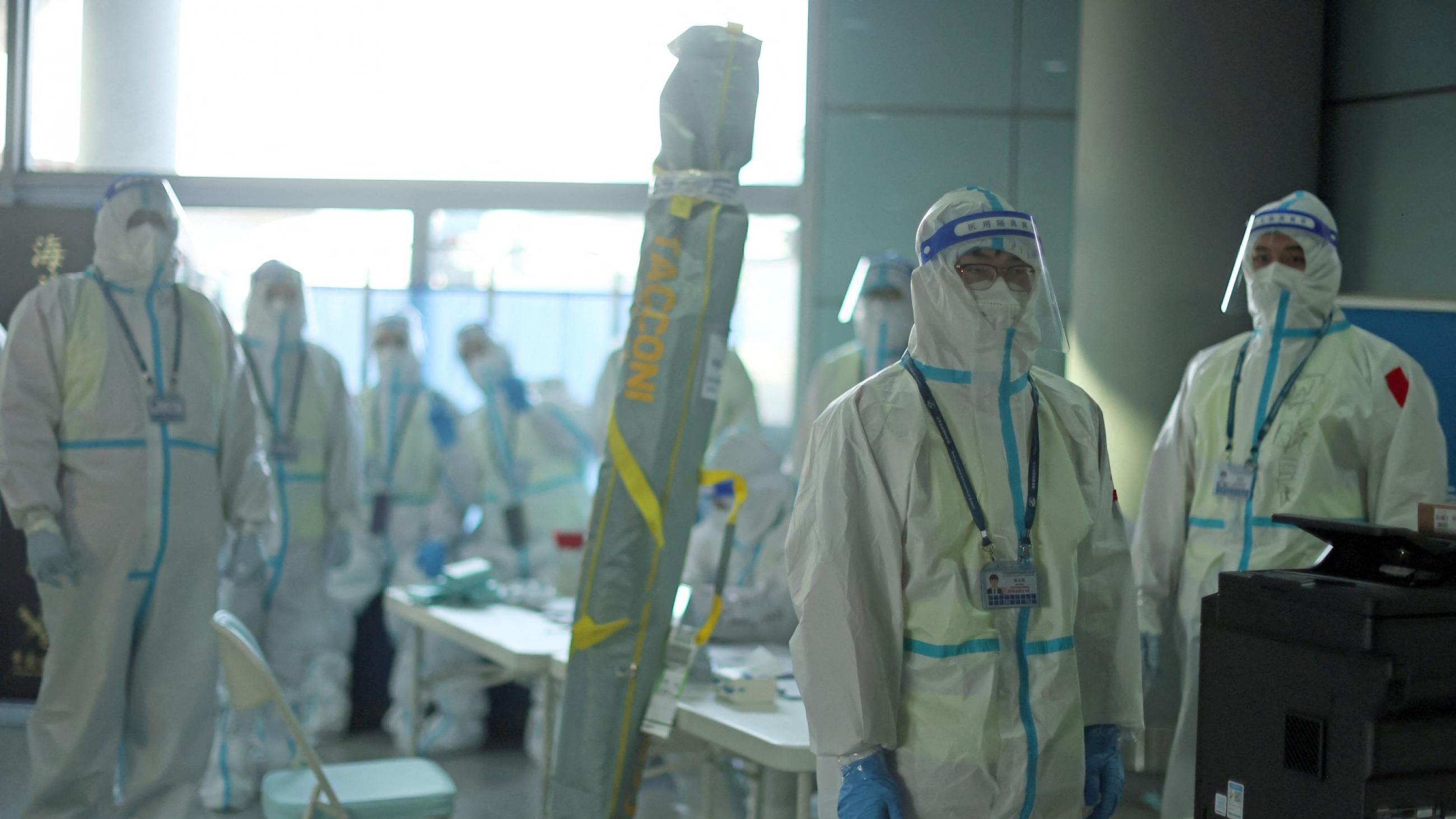 Staff members wearing personal protective equipment (PPE) designed to prevent the spread of the coronavirus disease (COVID-19), wait for passengers at Beijing Capital International Airport ahead of the Beijing 2022 Winter Olympics, in Beijing, China, January 31, 2022.