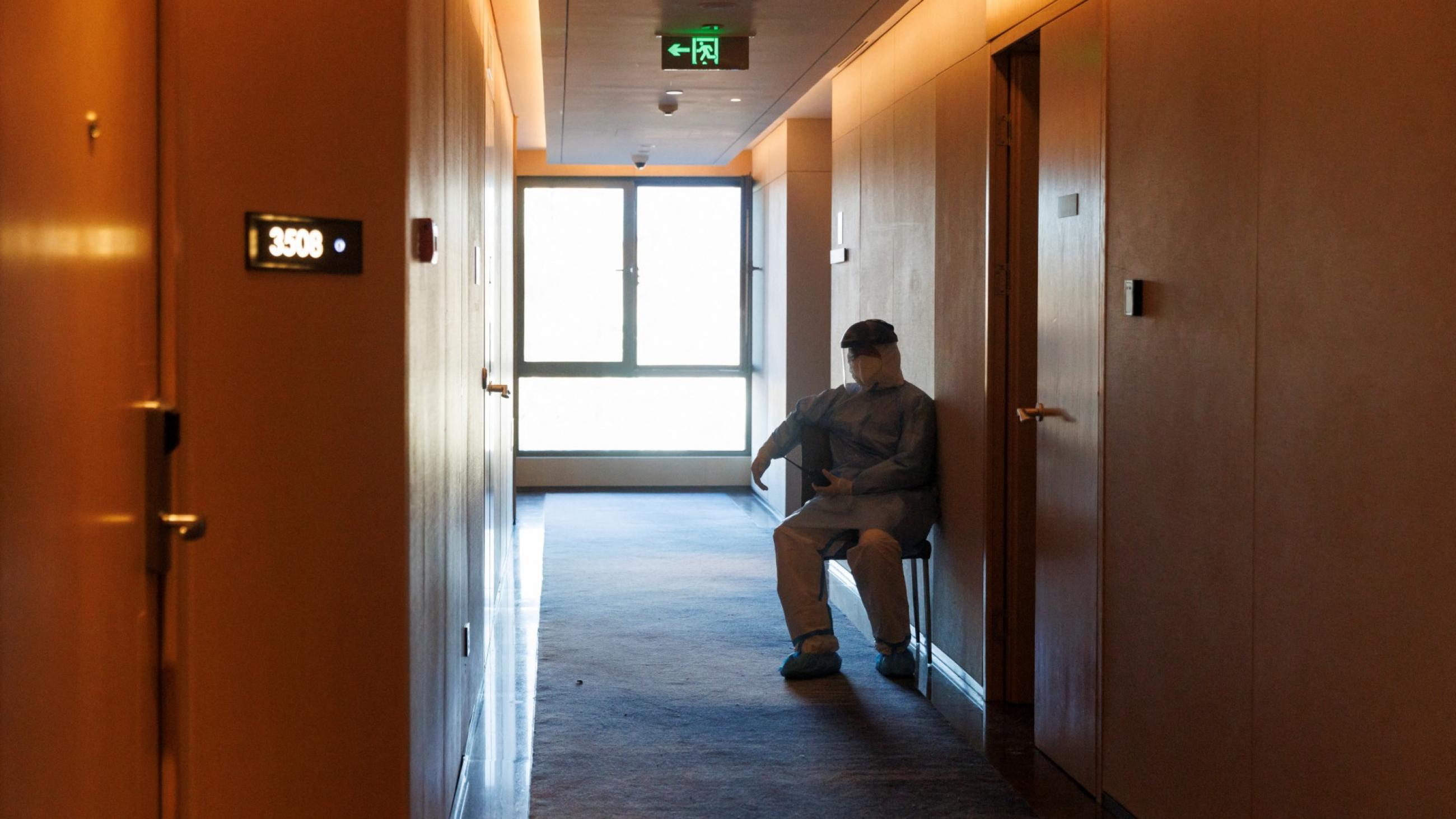 man sits in hallway