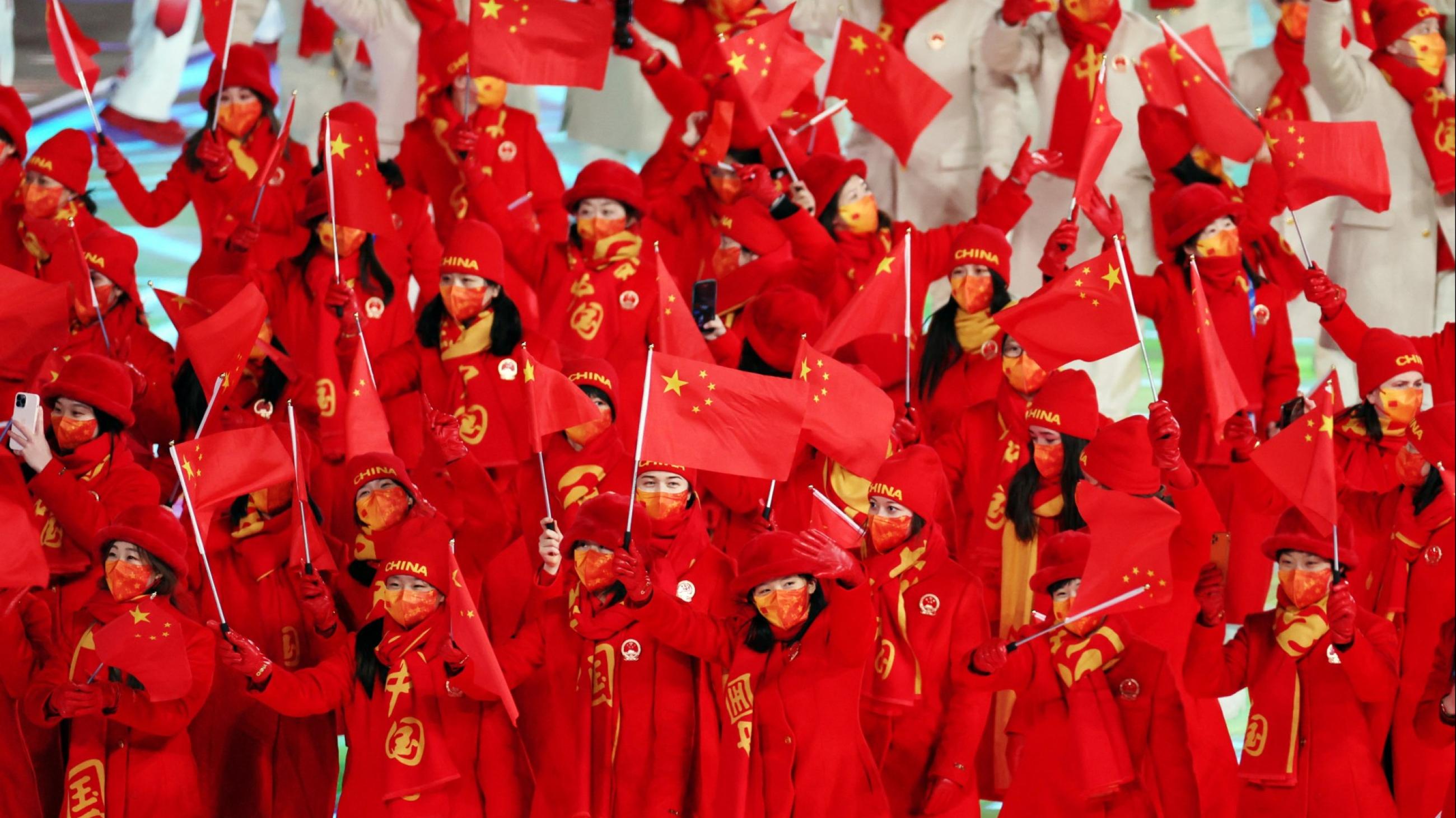 Athletes of China wave Chinese flags during the opening ceremony.