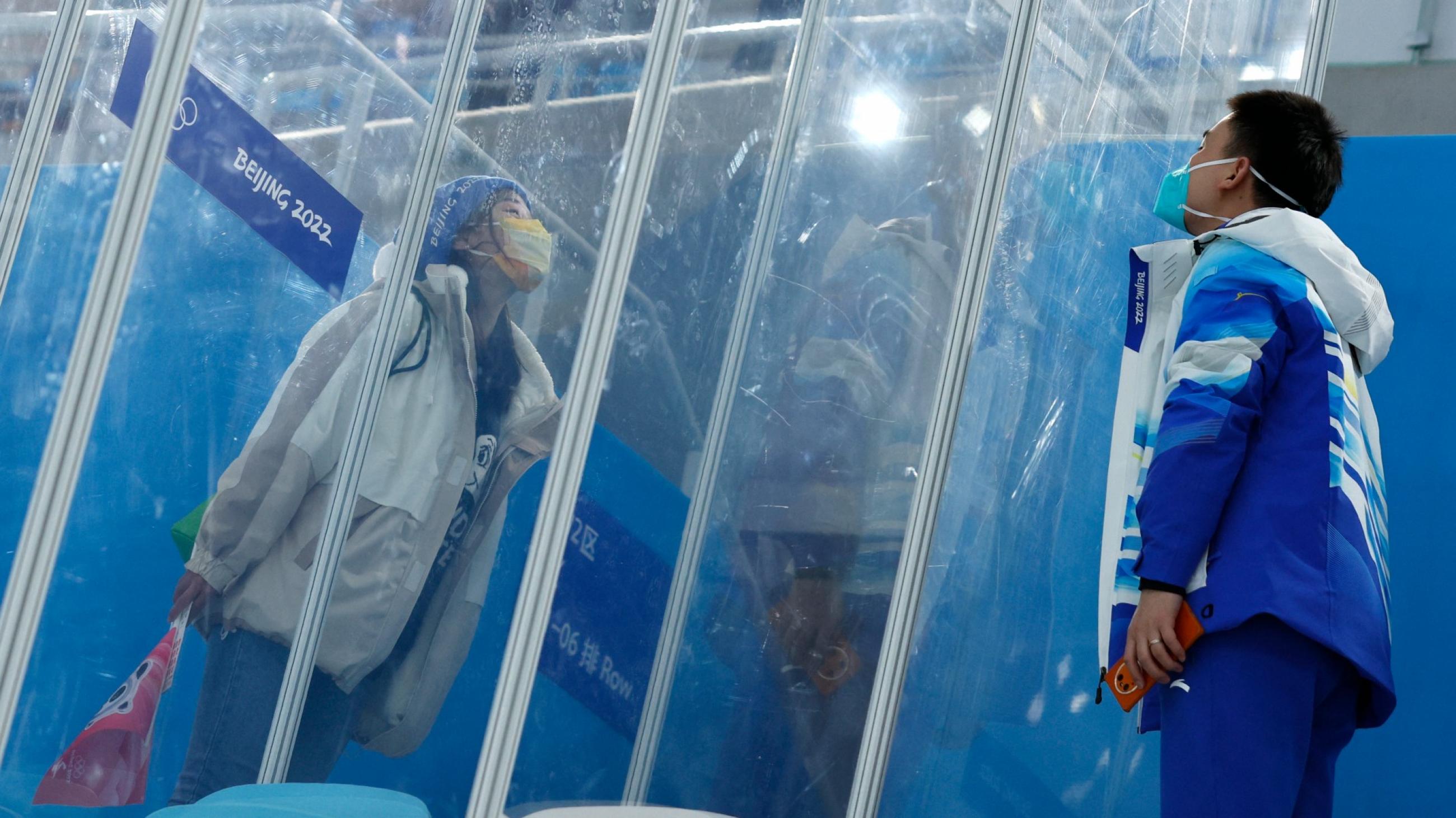 Dr. Ding Hongtao, part of the medical staff, blows a kiss to his girlfriend through screens of glass that separate them because of the "closed loop," a coronavirus disease (COVID-19) prevention measure