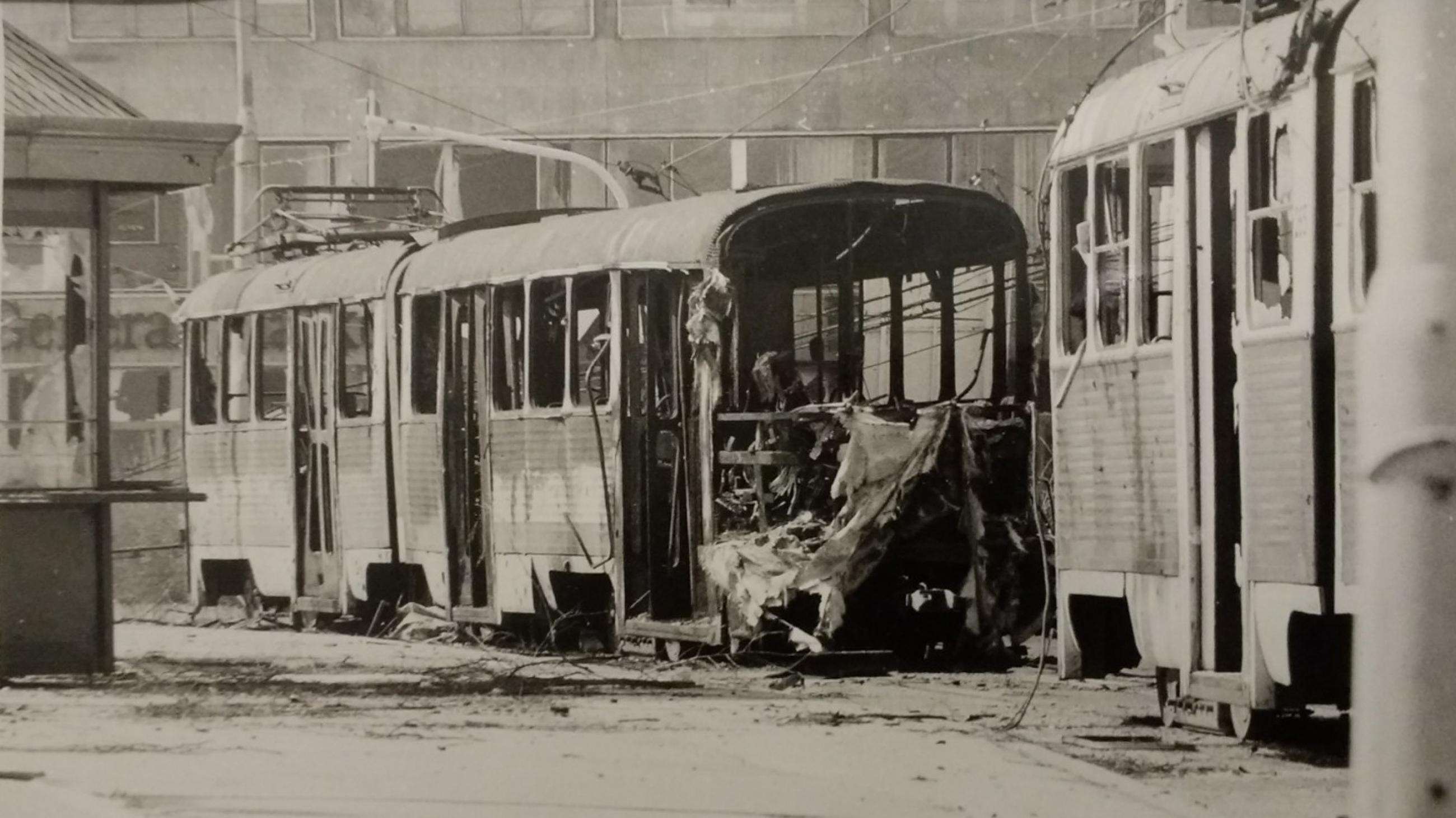 Black and white photo of shelled trams on Obala Kulina bana street