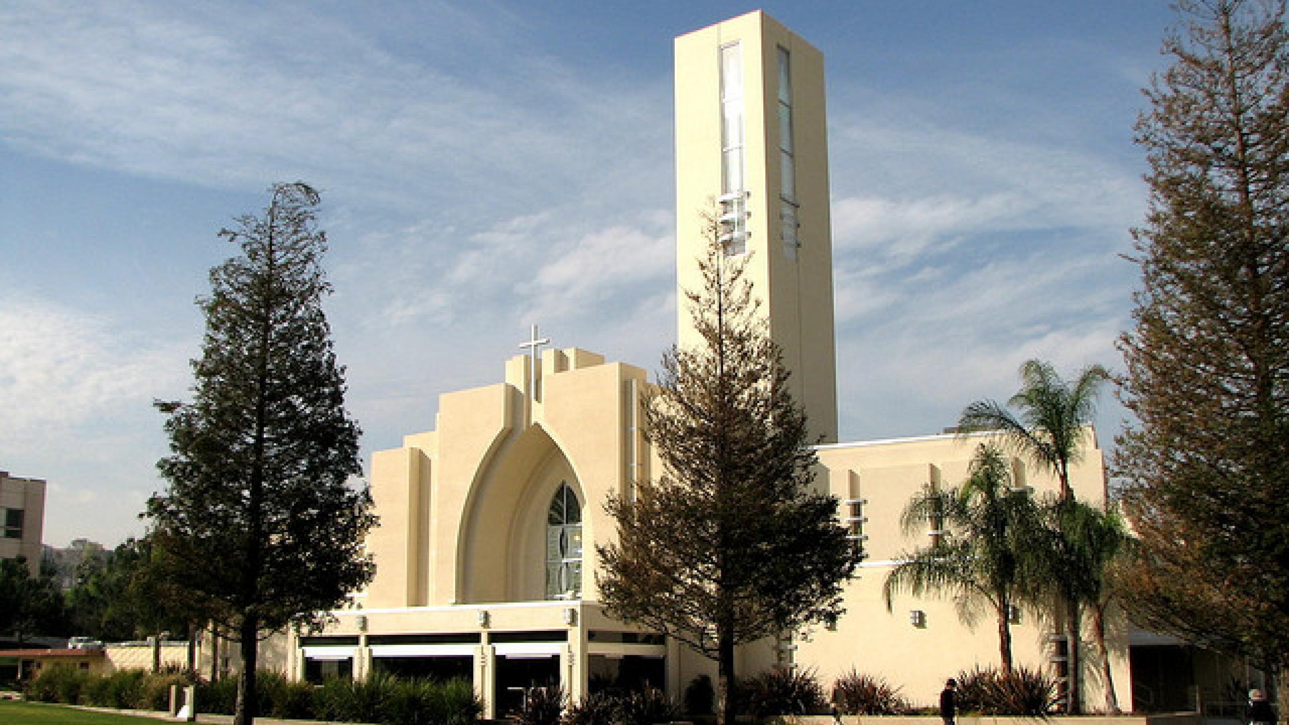 The Loma Linda University church, a white contemporary building, is seen against a blue sky