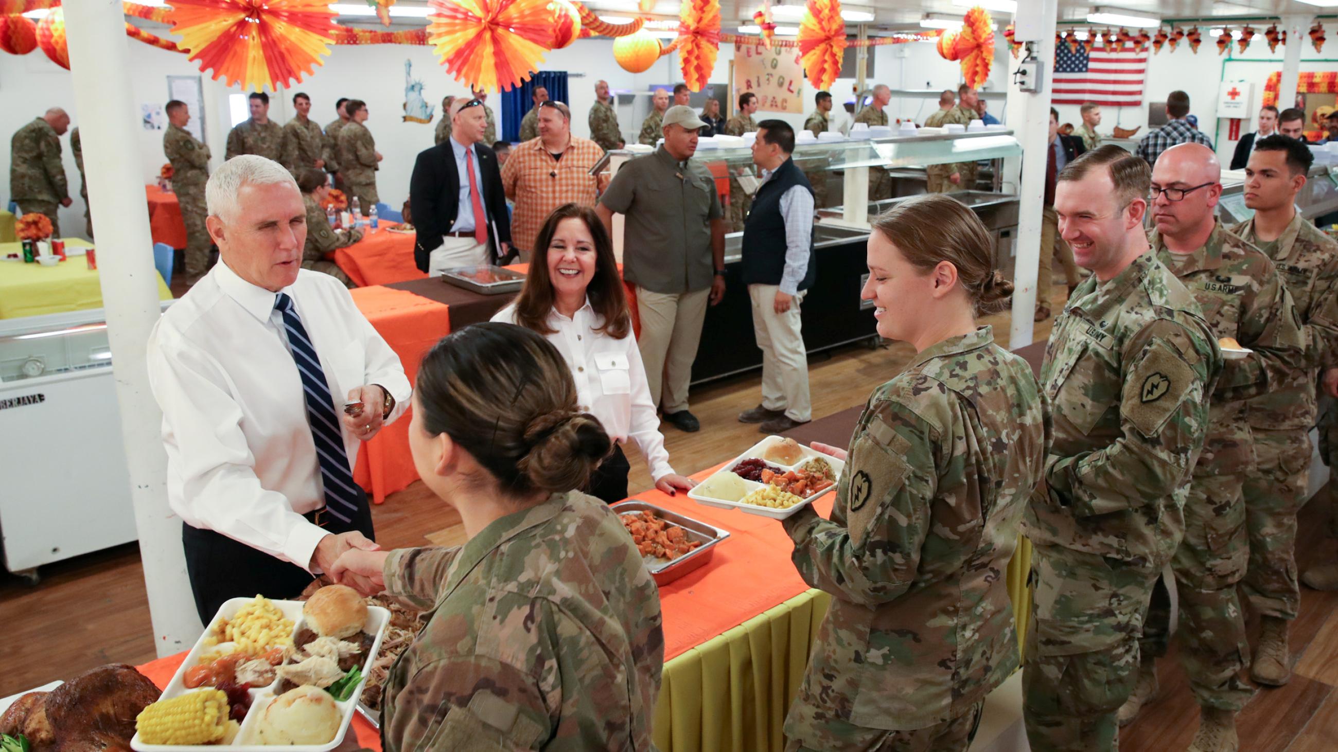 U.S. Vice President Mike Pence and his wife Karen Pence helped serve a Thanksgiving meal to U.S. troops in a dining facility at Camp Flores on Al Asad Air Base, in Iraq, on November 23, 2019.  