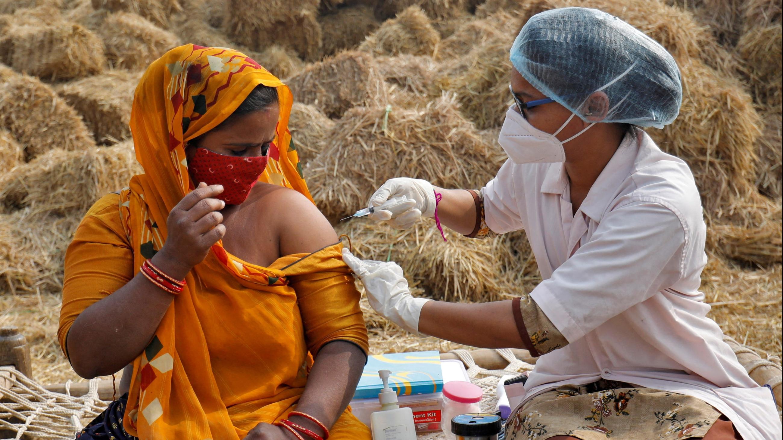 A woman receives a dose of COVISHIELD vaccine against COVID-19, that's manufactured by Serum Institute of India.